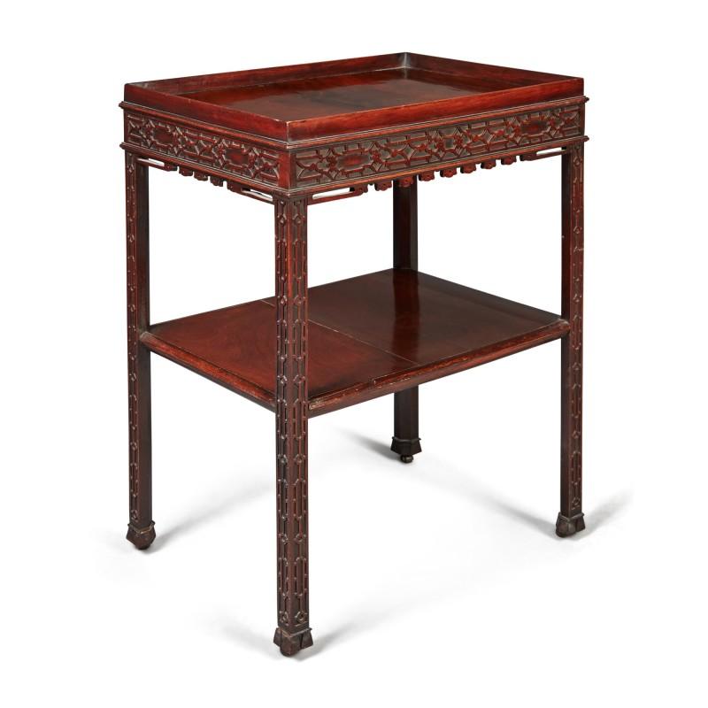 A fine quality 19th century George III style two-tier table in mahogany with blind carved fretwork decorated frieze and legs, and a handy lower shelf, raised on casters. Ideal as an end table or a bar. Solid and ready to use.

Provenance: