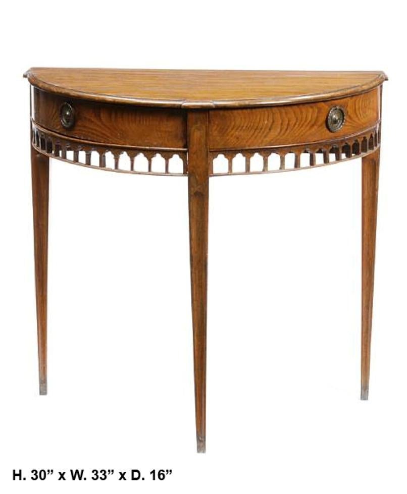 Attractive English George III style carved oak demilune console table with two drawers and with fretwork apron, mid-19th century. 
Measures: H 30