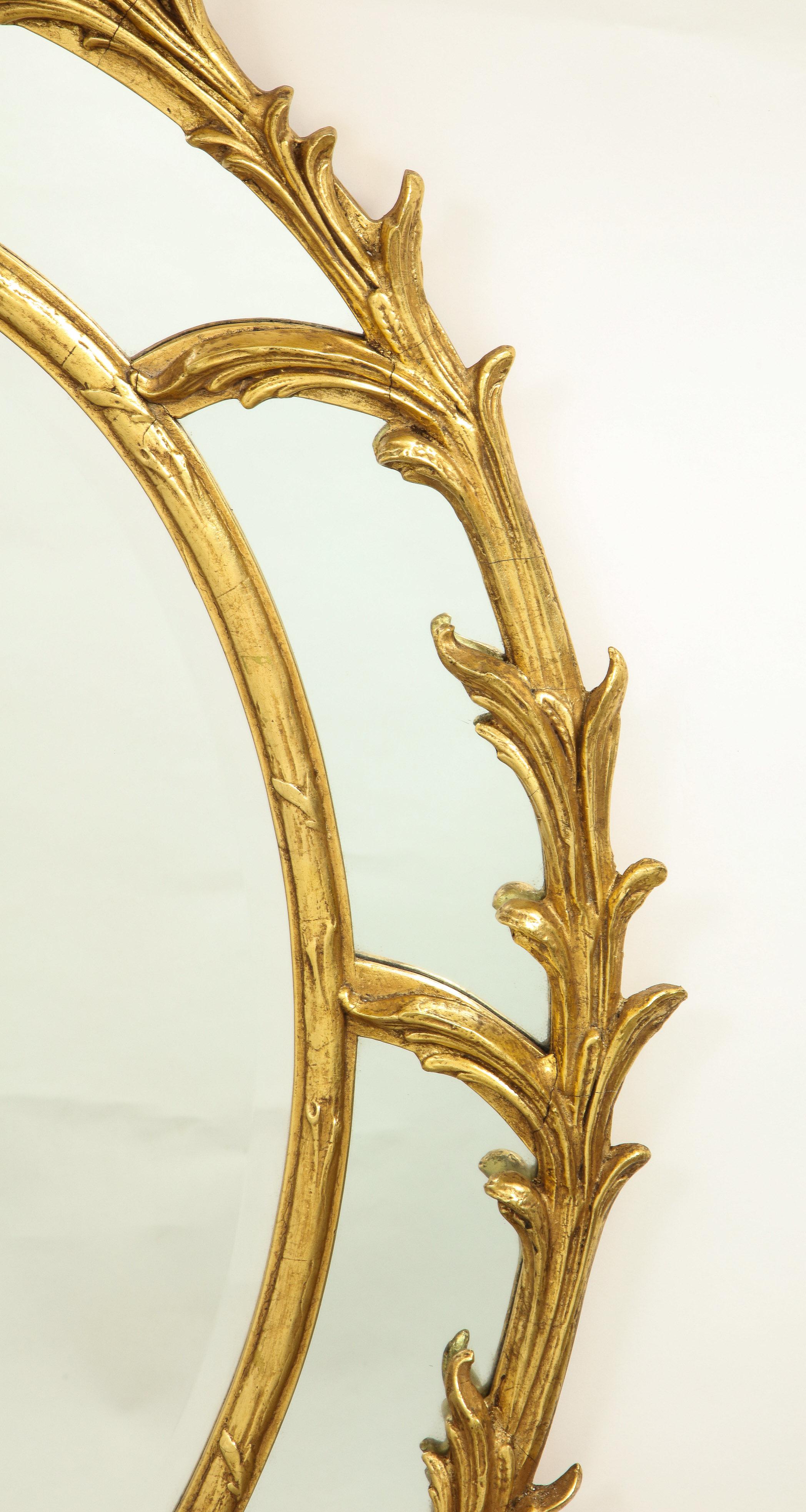 Within a foliate-carved frame surmounted by a foliate clasp. Mounted with hanging wire on back.