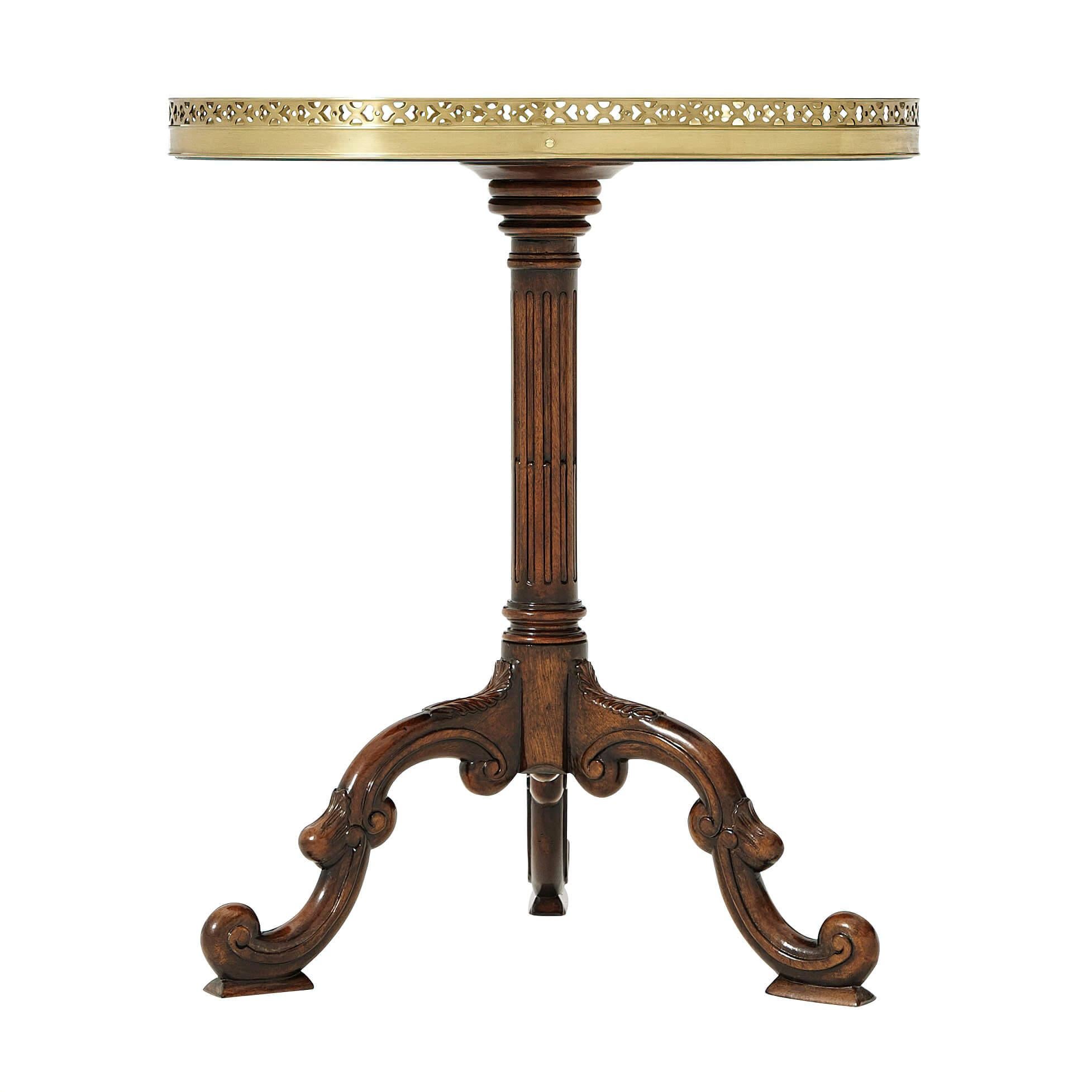 An English mahogany and burl sunburst parquetry oval lamp table, with a pierced brass gallery and fluted column, on 
