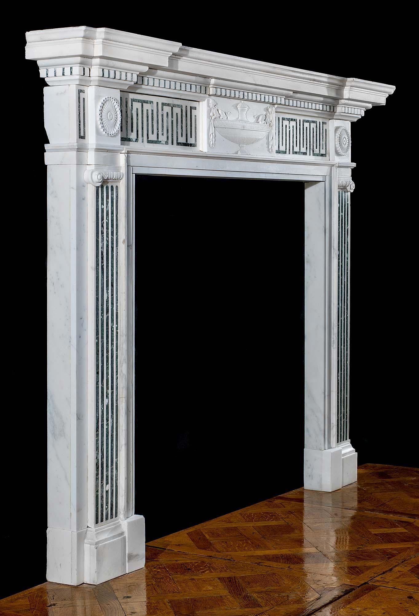 A fine statuary marble Victorian chimneypiece with grey/green Verde Antico Marble inlay very much in the George III manner. The wide moulded shelf, with an underlay of dentil detail, rests above an inlaid Greek Key frieze with a central tablet of an