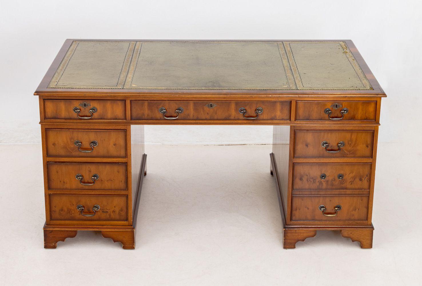 George III Style Yewood Pedestal Desk, with gilt tooled green leather top above central long drawer flanked by eight drawers. 30.5