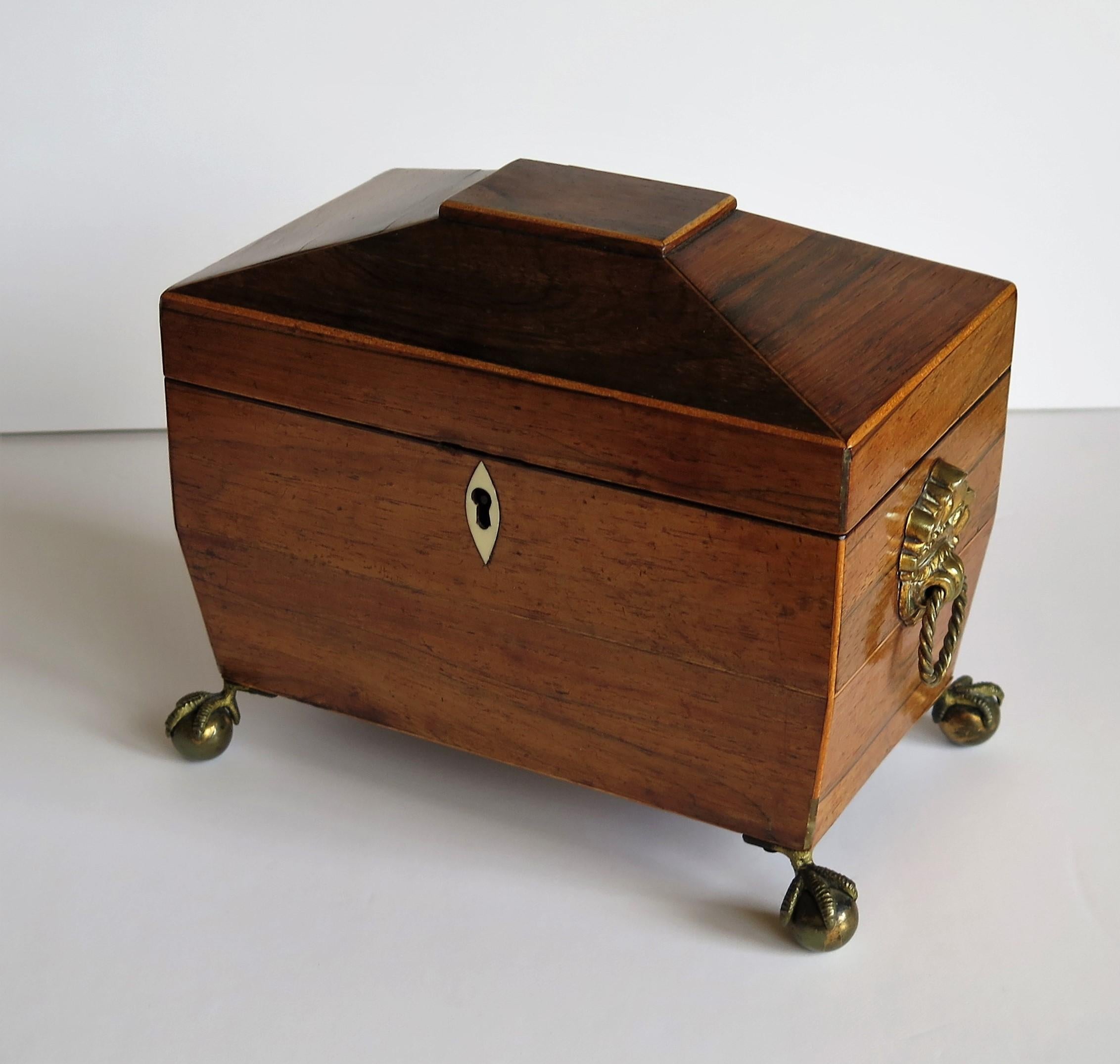 This is a good, high quality, English, Georgian period tea caddy, circa 1815.

The tea caddy has a sarcophagus shape with two lidded internal compartments.
It has been very carefully hand made of various contrasting woods. The main body is