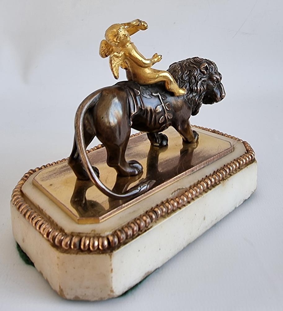 Patinated George III Thomas Weeks Paperweight of Cupid Riding a Lion For Sale