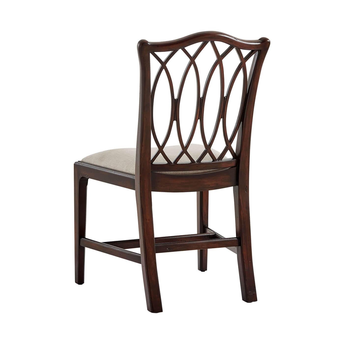 George III style mahogany dining chair with a serpentine side chair, with an interlacing trellis back, above a bowed upholstered seat, on chamfered legs. The original George III circa 1780.
Dimensions: 21.25