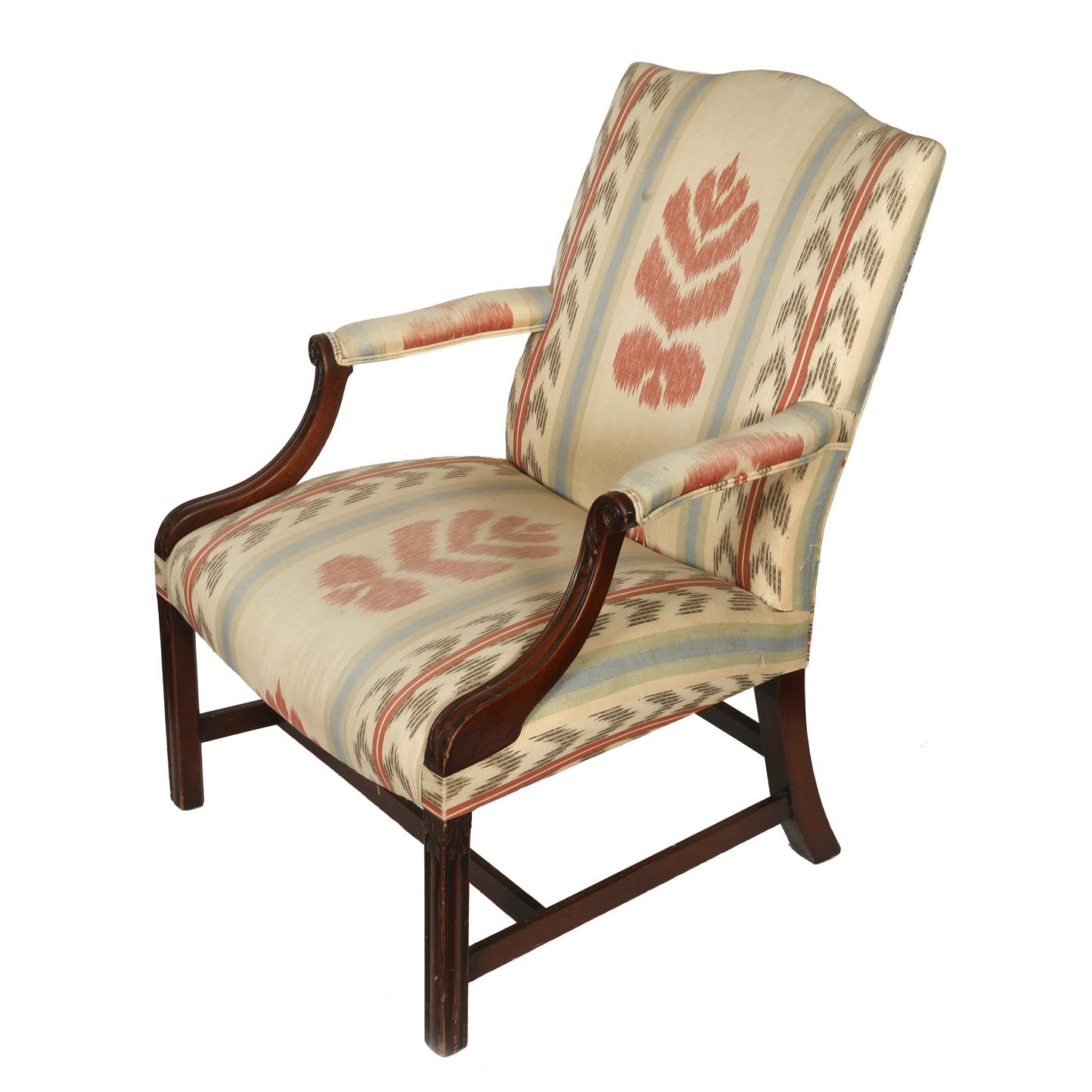 George III upholstered library chair with mahogany frame and upholstery in cream, red and blue ikat stripe pattern.