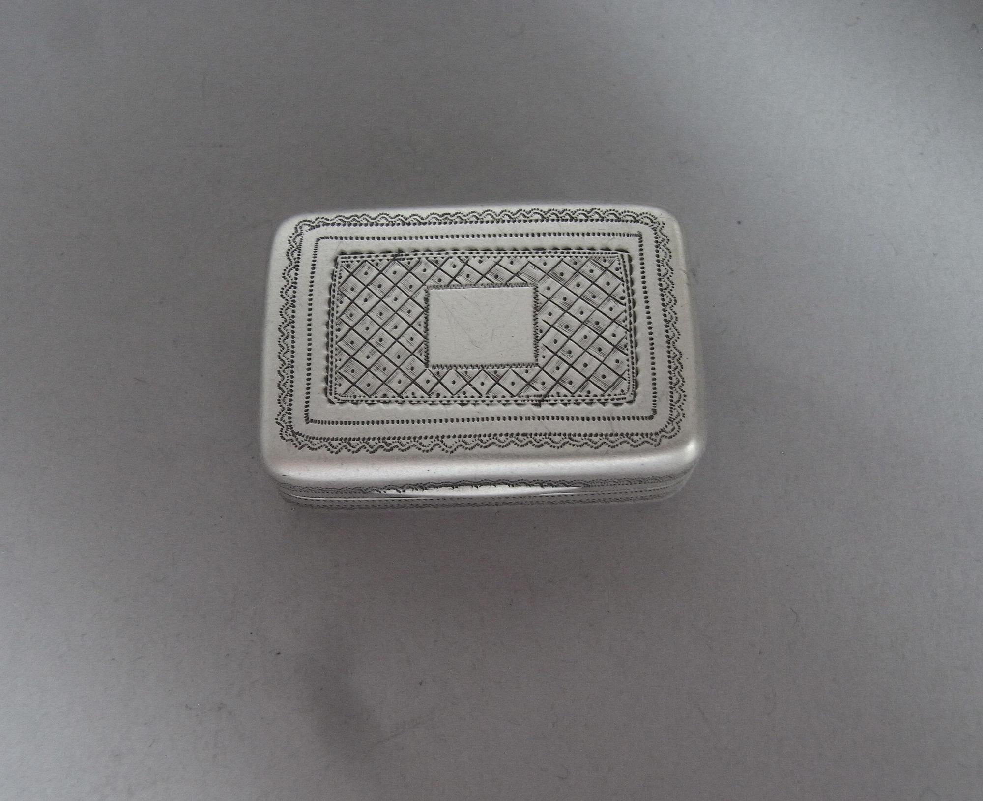 A fine George III Vinaigrette made in London in 1812 by Joseph Ash.

The Vinaigrette is broad rectangular in form and the cover is engraved with prick dot bands around a trellis work panel and vacant cartouche. The base is engraved with an outer