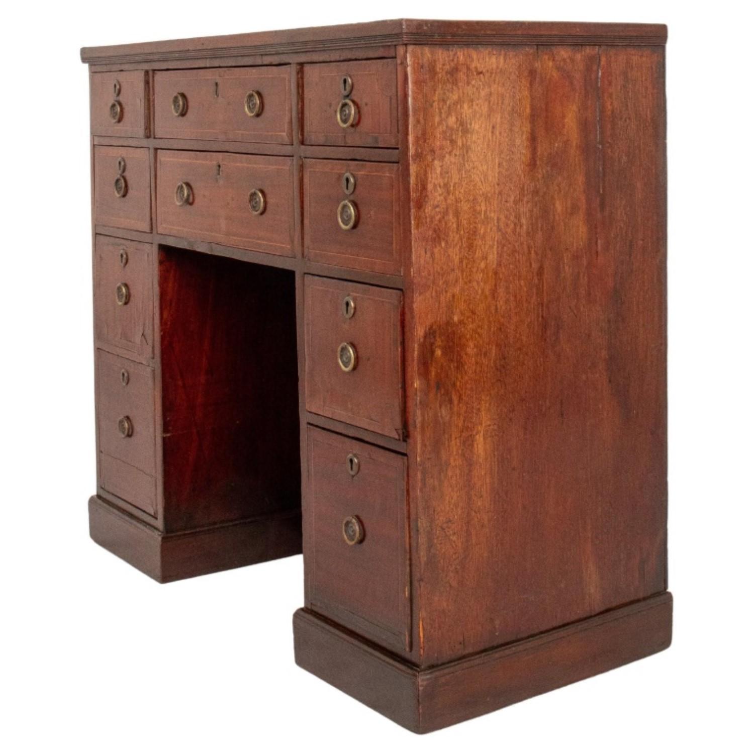 
The George III Walnut Tall Kneehole Desk, dating from around 1800, features 9 short drawers.

 Its dimensions are approximately 35 inches in height, 38.5 inches in width, and 18 inches in depth.