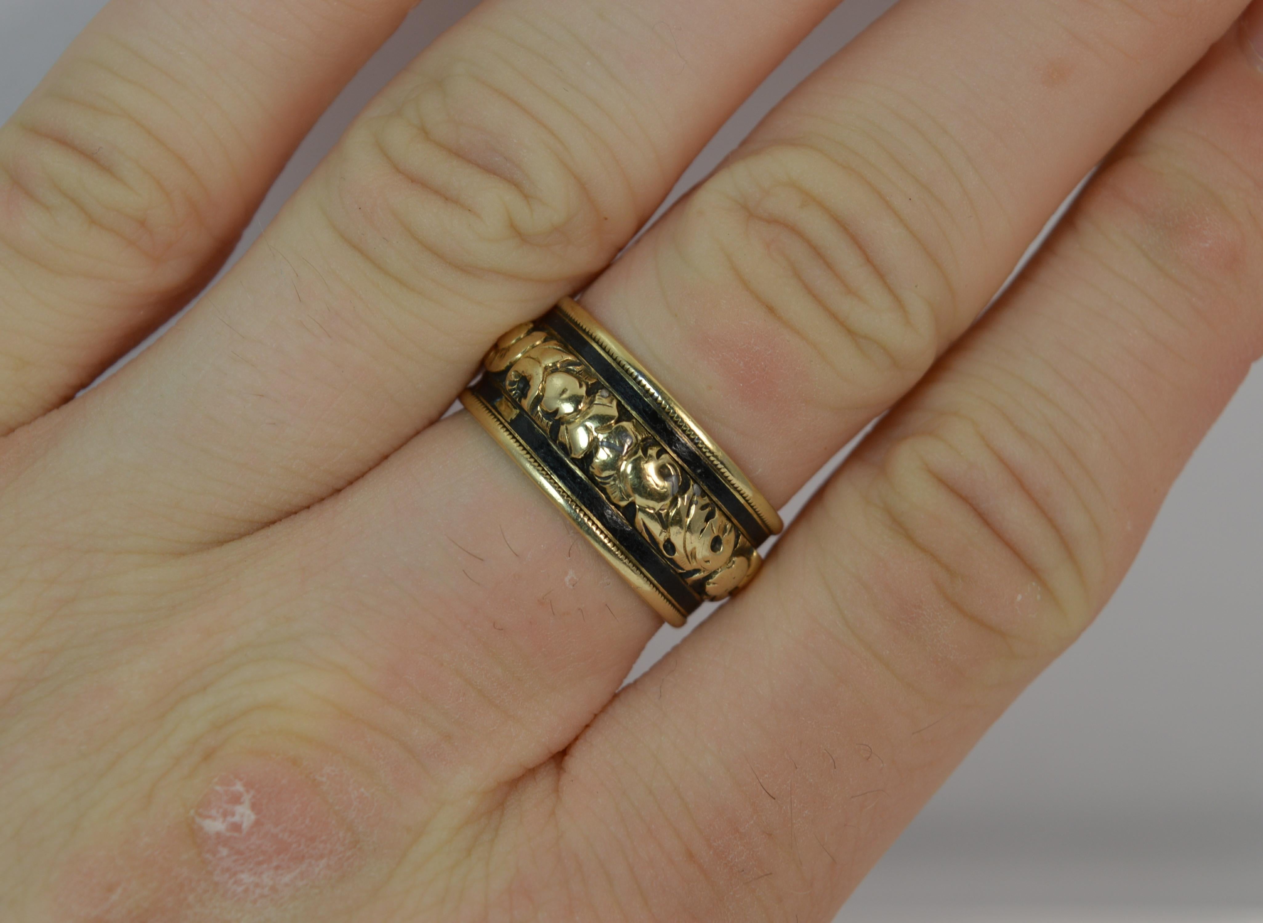 
A rare George IV period mourning stack ring.

Solid 18 carat yellow gold example.

​Designed with floral design throughout the centre of the piece. The black enamel runs throughout above and below and gold edge.

​9.6mm wide throughout.

Engraved