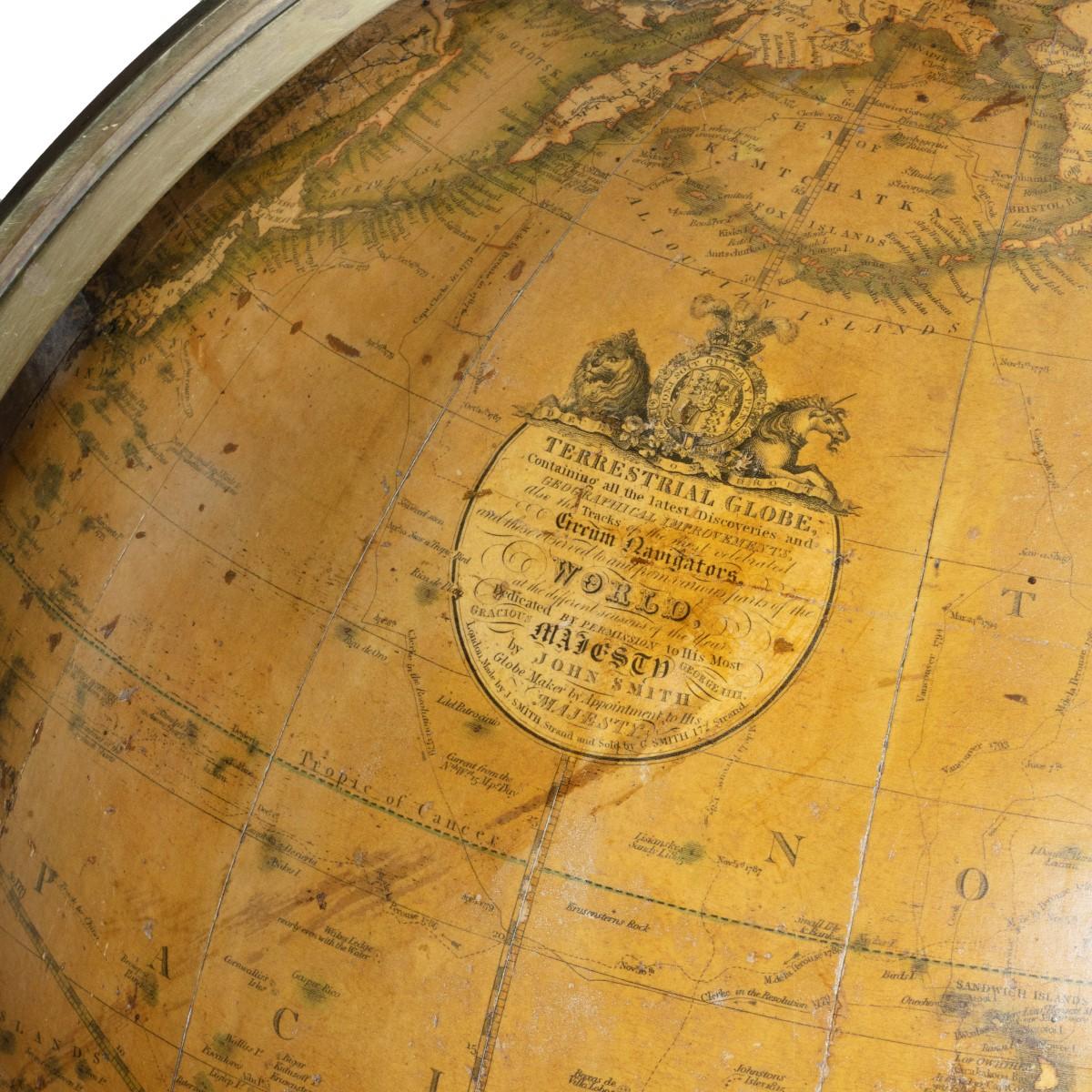 A George IV 18 inch George Smith terrestrial globe, set in a mahogany tripod Stand with a turned baluster support and slender square-section legs with the original castors. Compass dish and rose replaced. Signed within an elaborate roundel