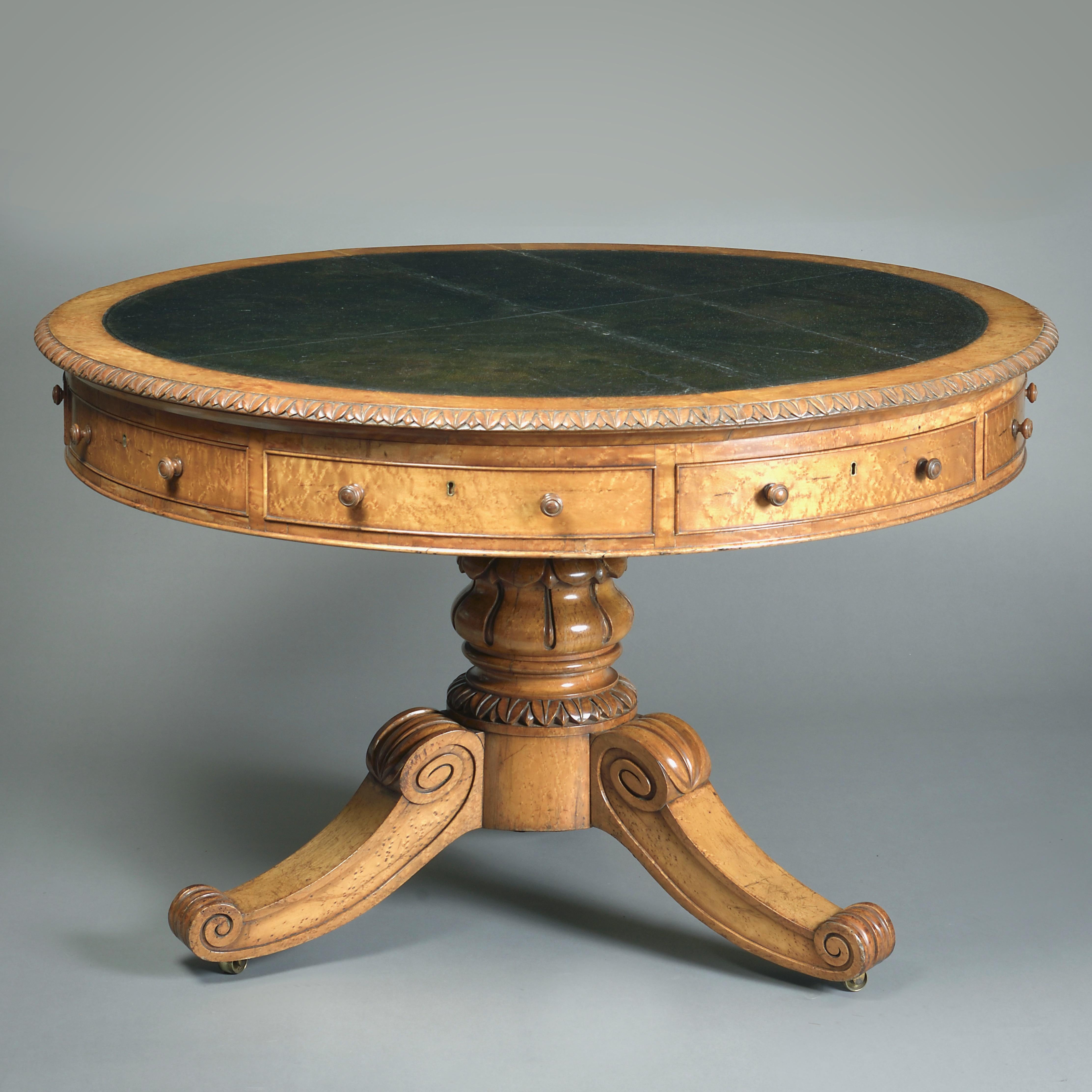 A FINE GEORGE IV BURR-MAPLE CENTRE TABLE, CIRCA 1825.

The circular top with it’s original inset blind-tooled green Morocco leather, the frieze fitted with four mahogany lined drawers alternating with false drawers.