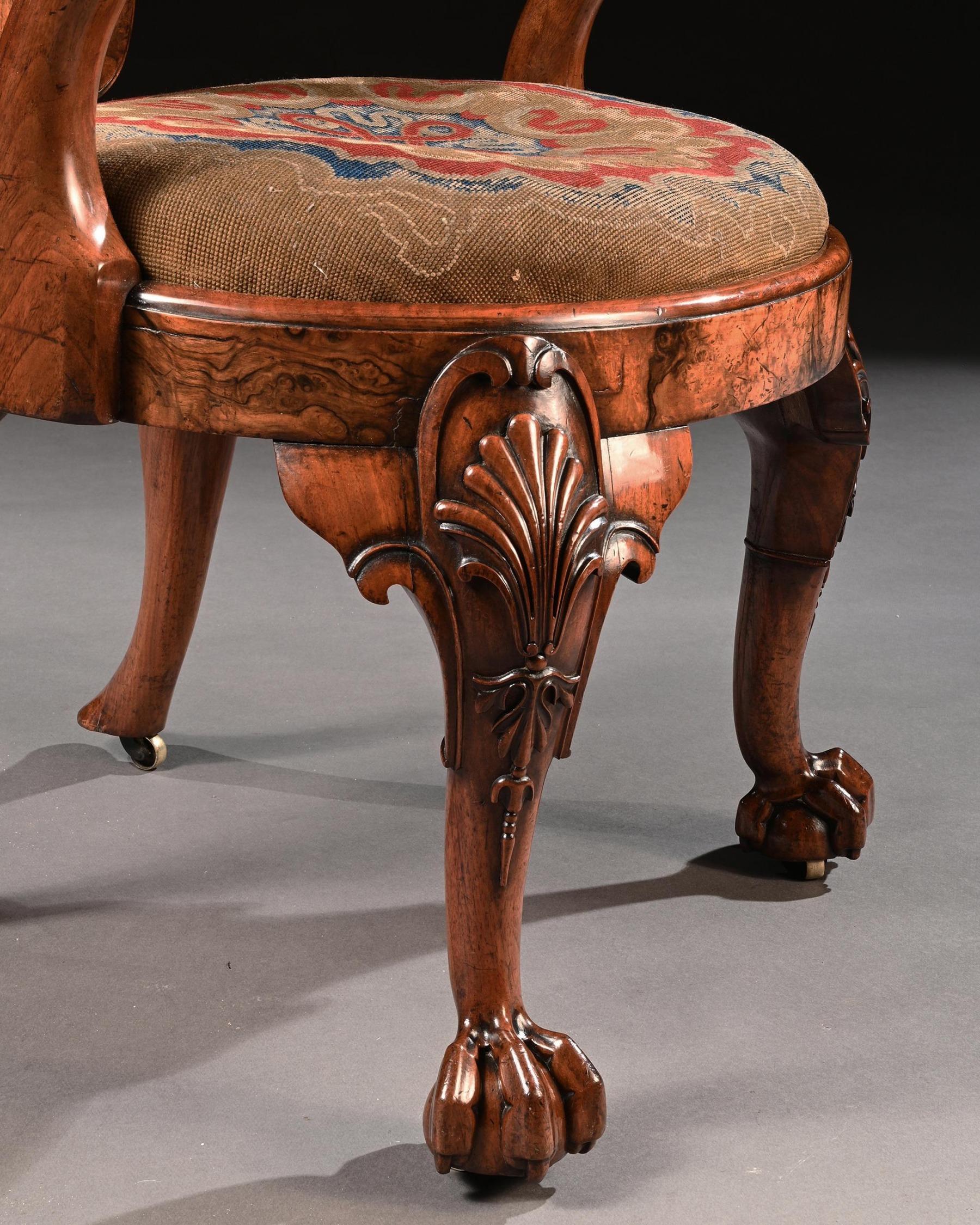 George IV burr walnut shepherds crook escutcheon back library armchair firmly attributed to gillows.



English circa 1825-30.



The channeled cartouche shaped (also known as escutcheon shaped) incurved back above shepherds crook arms, the