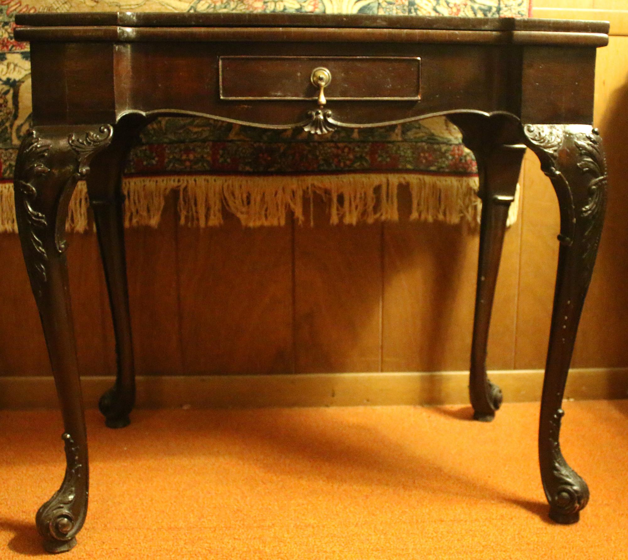 Very rare matched pair of George II (1727-1760) mahogany Irish game tables with original petit point inserts. Original, untouched finish. Accordion action for top support, that once extended, provides full apron around table.  Intricately carved