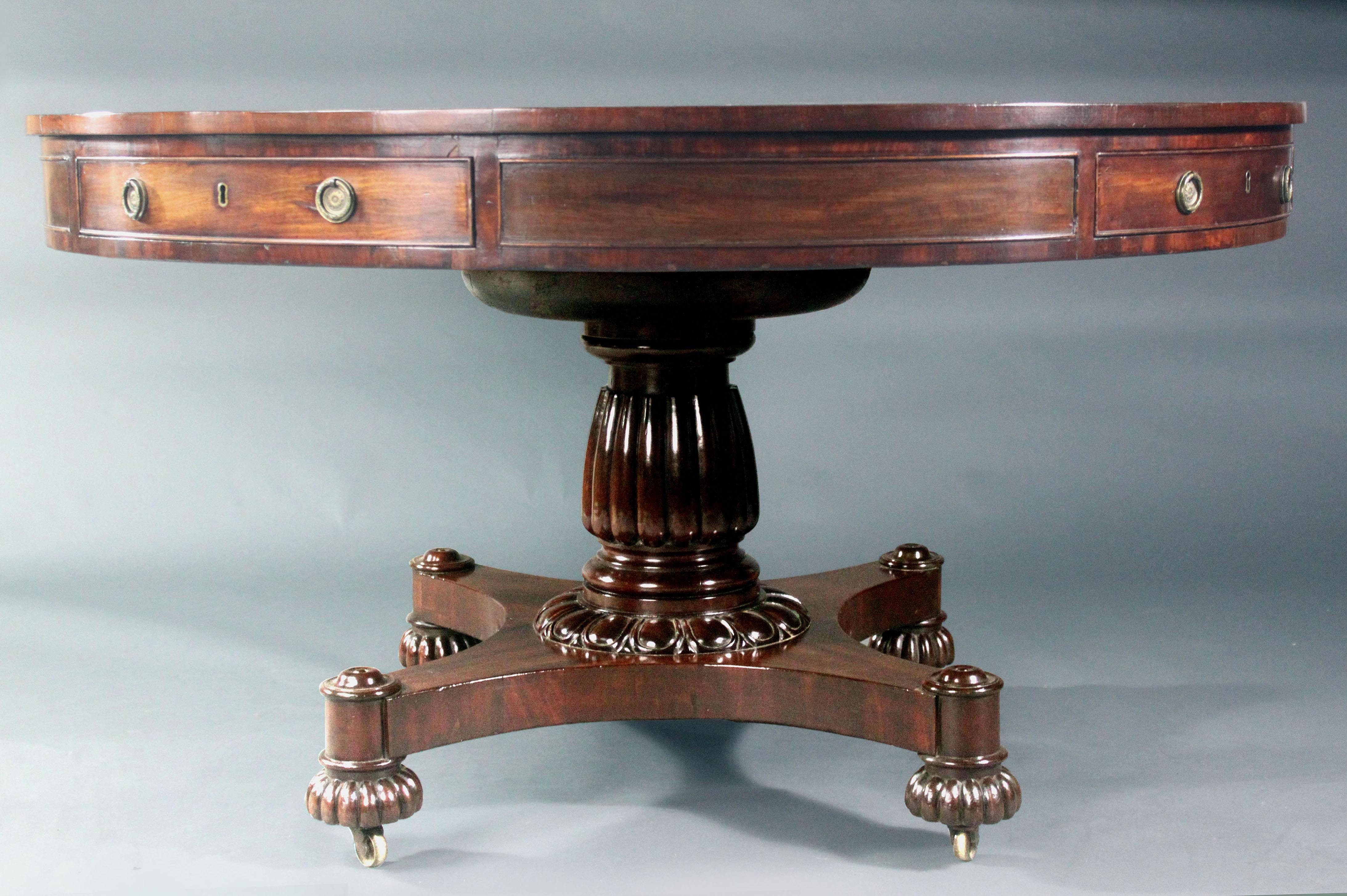George IV Mahogany Drum Table
A good George IV mahogany drum table on carved reeded stem, platform base and reeded bun feet; elegant shallow top, oak lined drawers and attractive old green leather top; the top revolves on a gimbal.
Good size 52.5