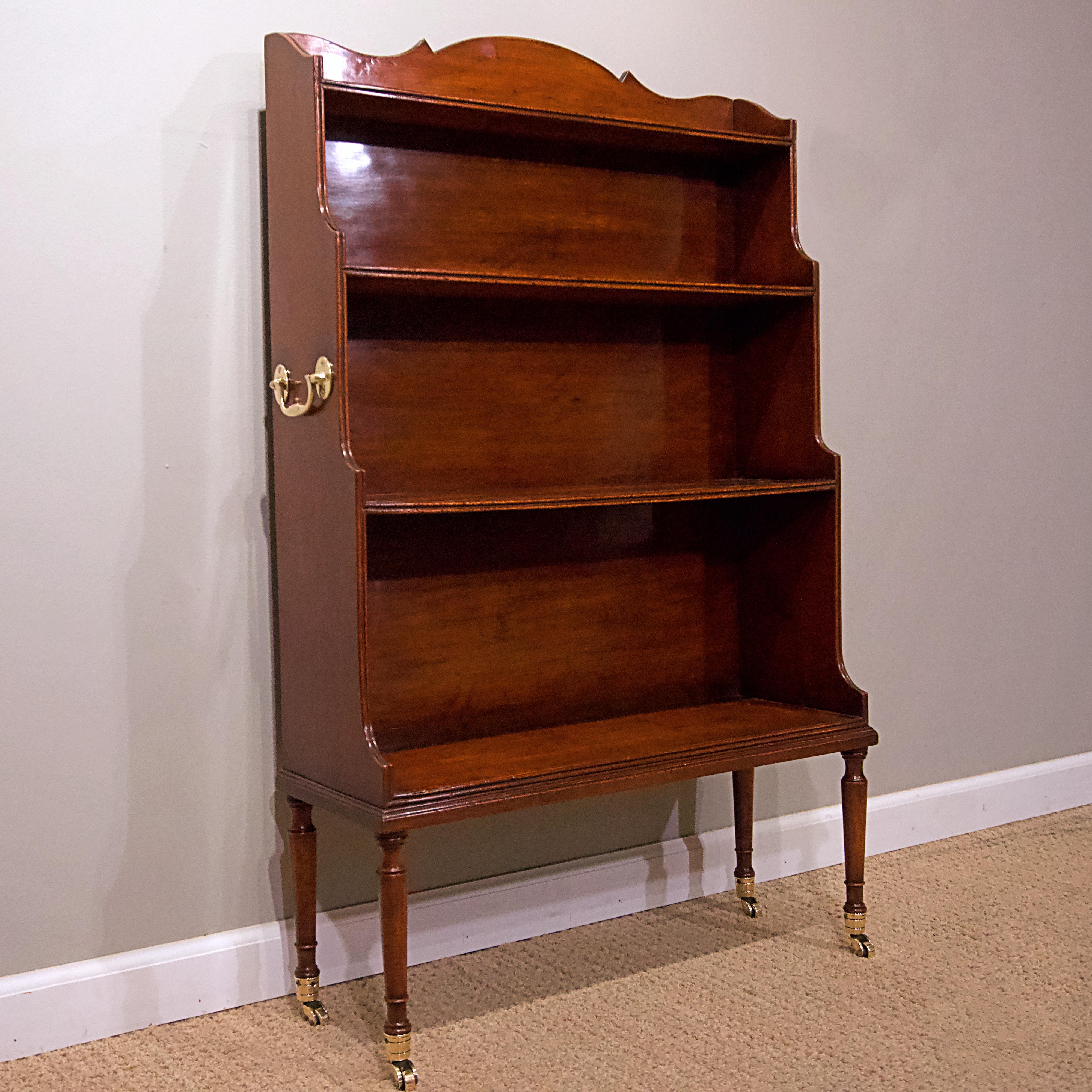 George IV mahogany library bookcase with brass castors.