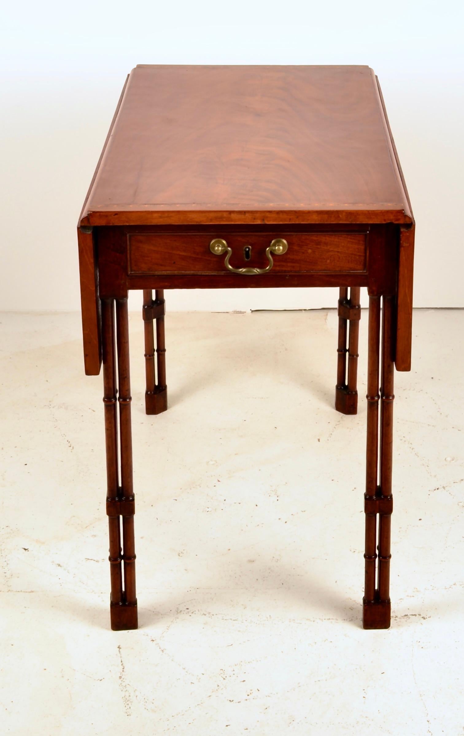 Beautiful French polish on this handsome George IV Pembroke table with tri-cluster faux bamboo legs, two rectangular drop leaves and center drawer. Purchased in 2000 from Jayne Thompson Antiques of Nashville, TN.  Very fine condition.
