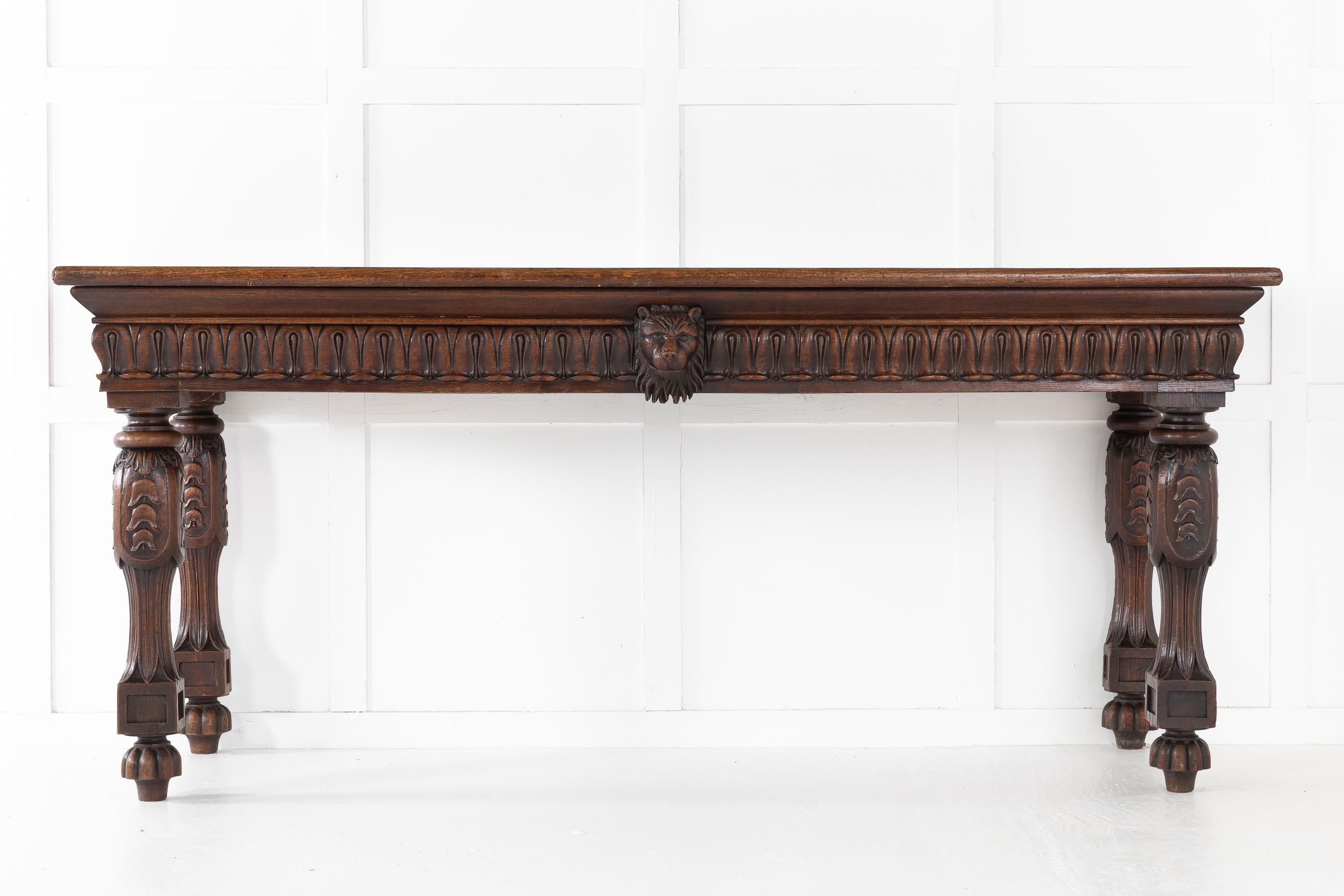 19th century, large scale, English serving table with nicely carved frieze with central carved lion's head and two drawers, supported by unusual carved legs.
 
