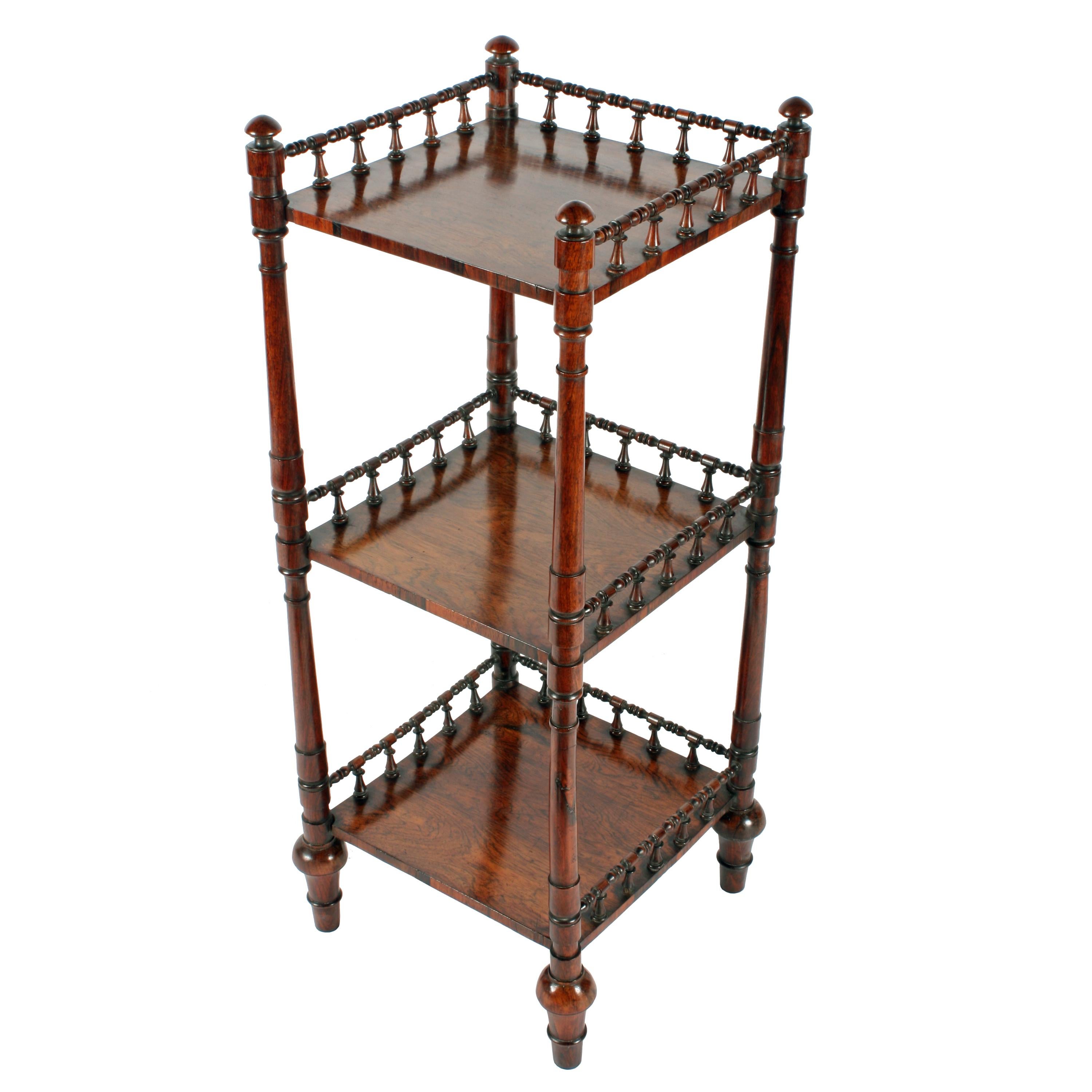 An early 19th century George IV rosewood three-tier étagère.

The étagère has a 'bobbin' turned rosewood gallery to three sides of each shelf and each tier is supported by turned rosewood vertical supports.

The étagère has tapering feet that