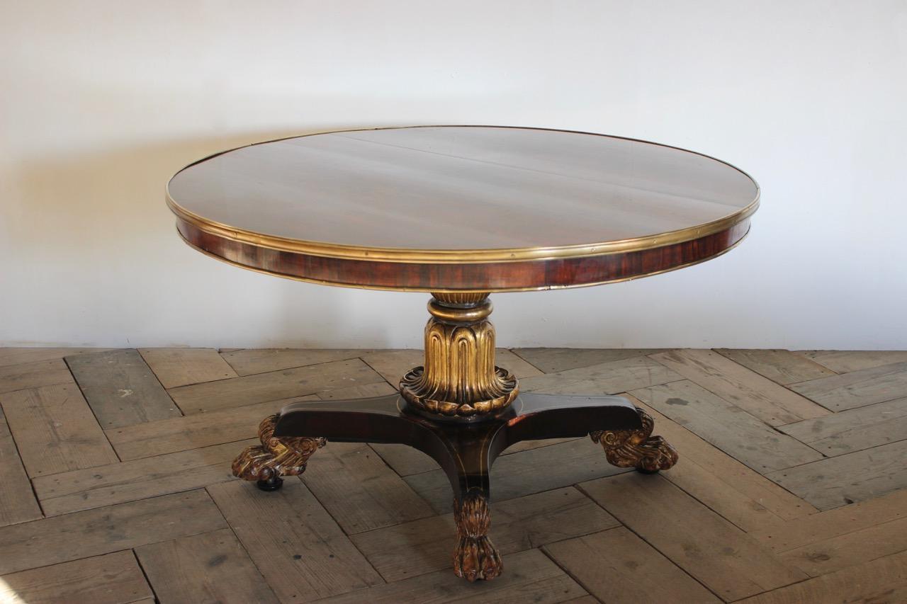 A fine quality English, George IV rosewood and giltwood centre table with bronze mounts and carved giltwood claw feet.
With patent castors, circa 1825.
 