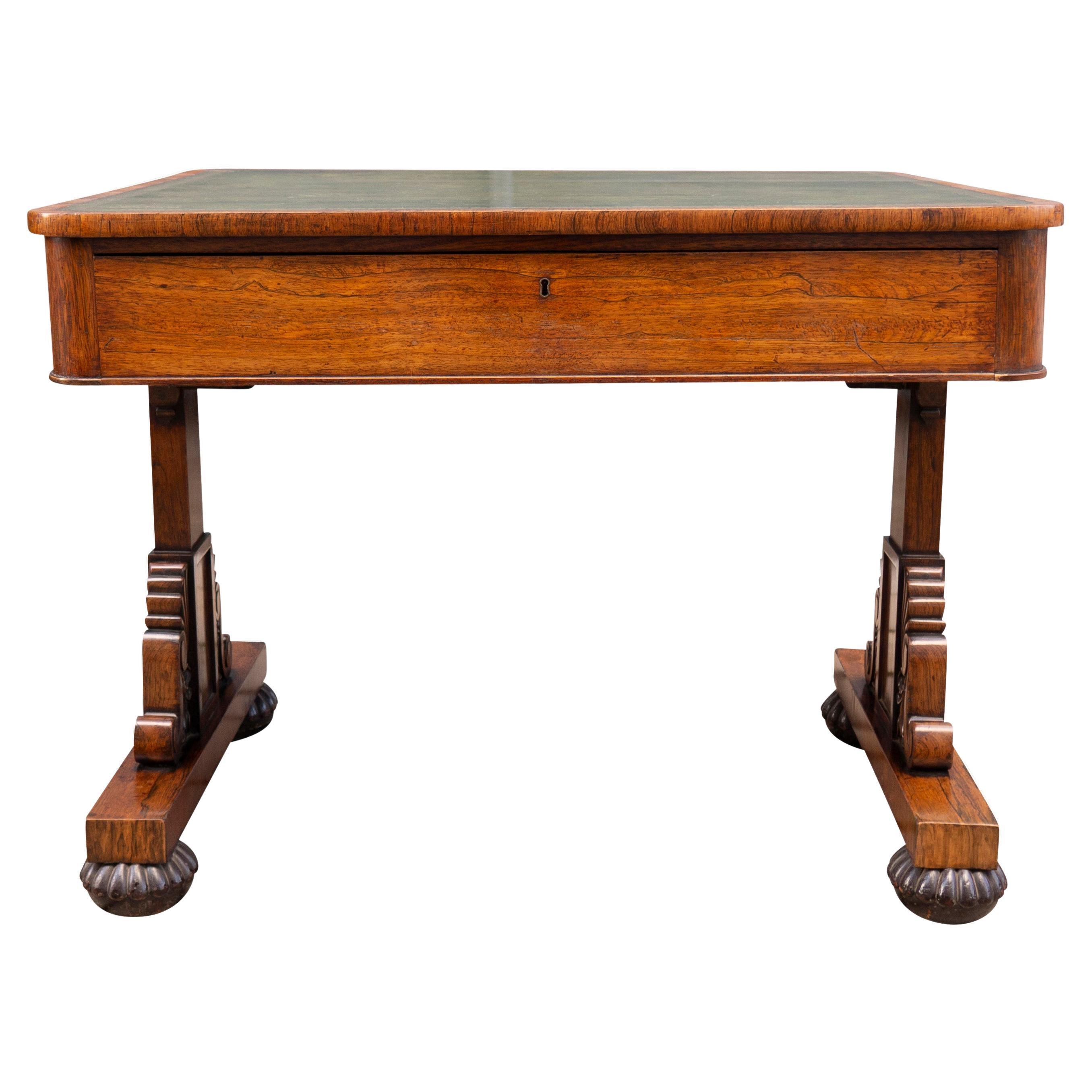 Signed Wilkinson , Ludgate Hill. With a squarish top with a nice green tooled leather , single long drawer,. trestle base with nice carved details , flattened bun feet and casters. Wilkinson was a noted highly regarded maker and received notable