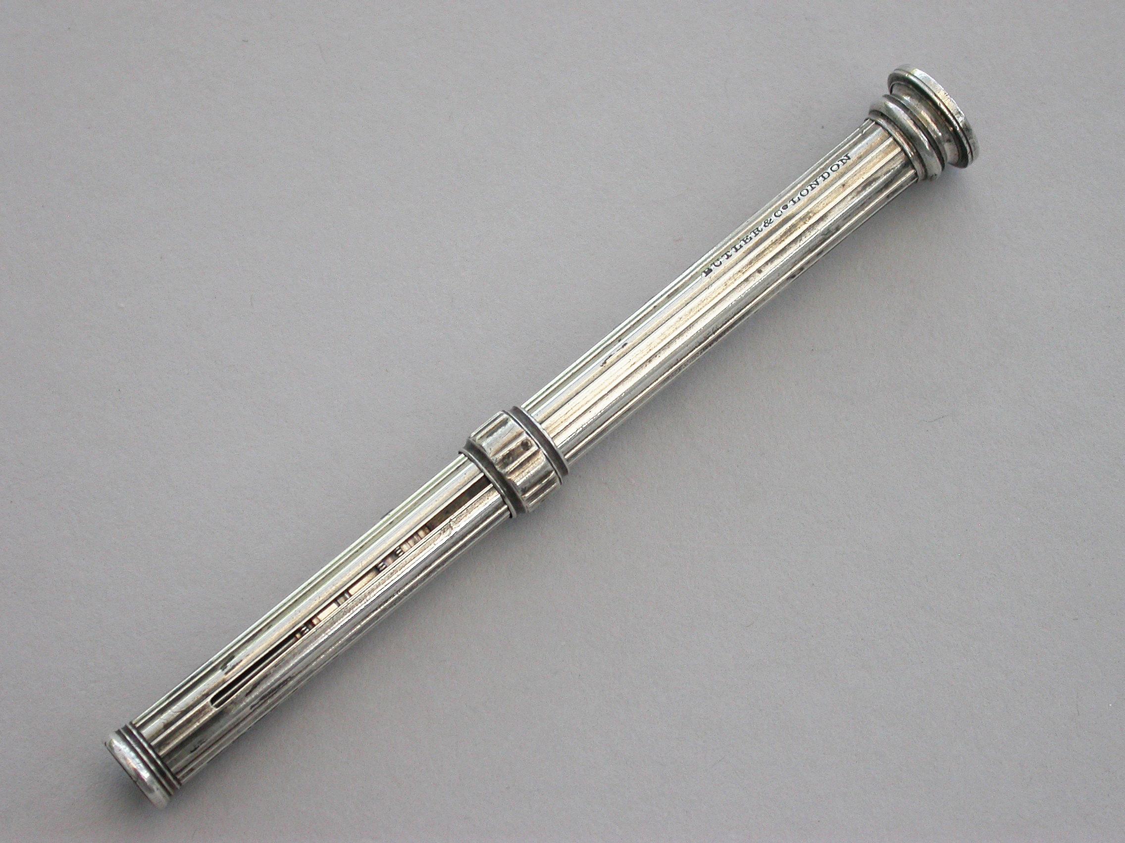 An early George IV silver sliding mechanical pencil with reeded barrel and hob-nail cut fixed terminal seal.

By Butler & Co, London, circa 1825.

The fixed terminal seal and the design of this pencil points to an early date.

Measures: Open