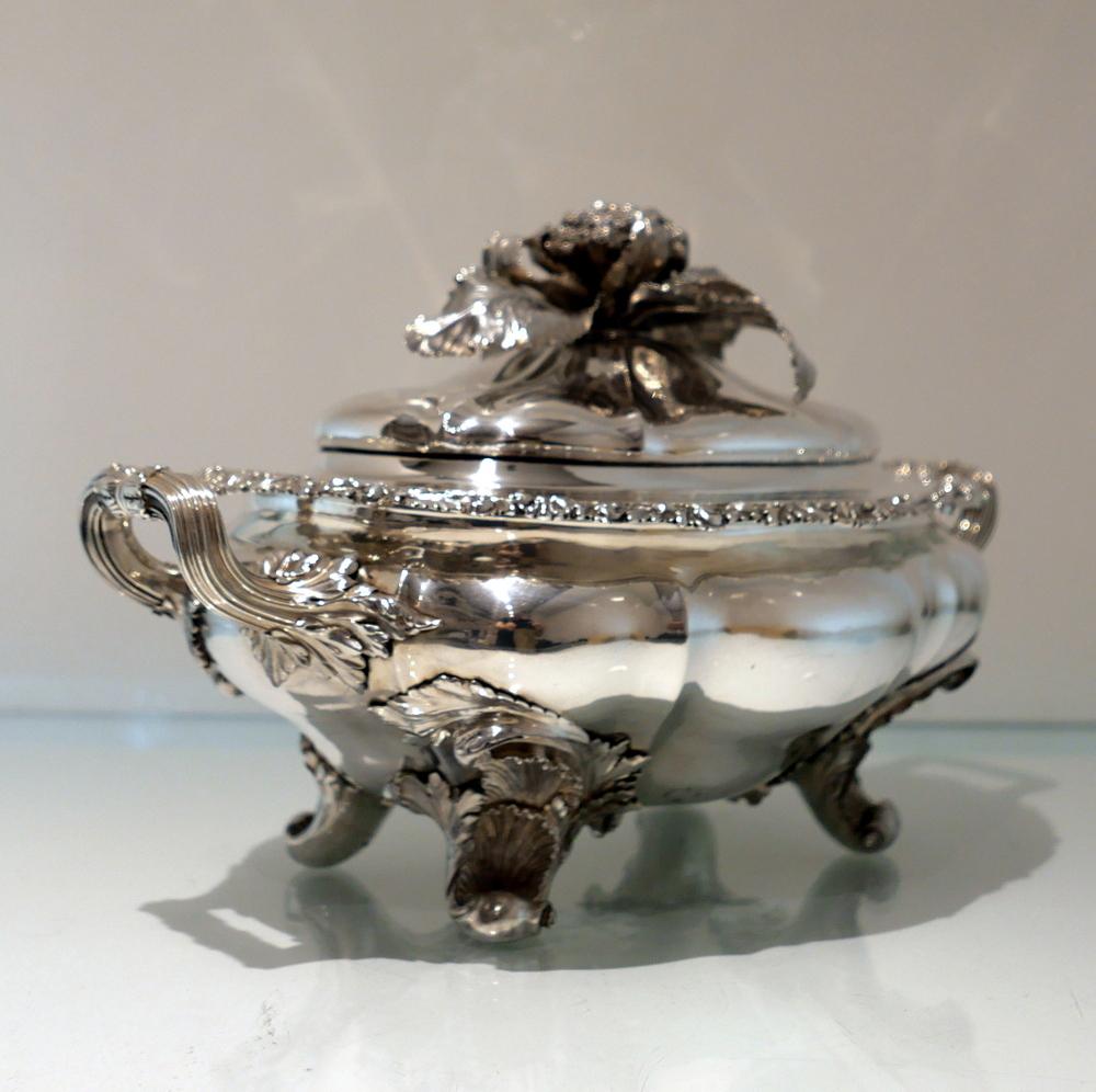 A truly exceptional quality shaped oval silver soup tureen decorated with floral and shell borders. The tureen sits on four impressive foliate feet and the detachable lid has a stunningly magnificent handle. The centre front of the body has a