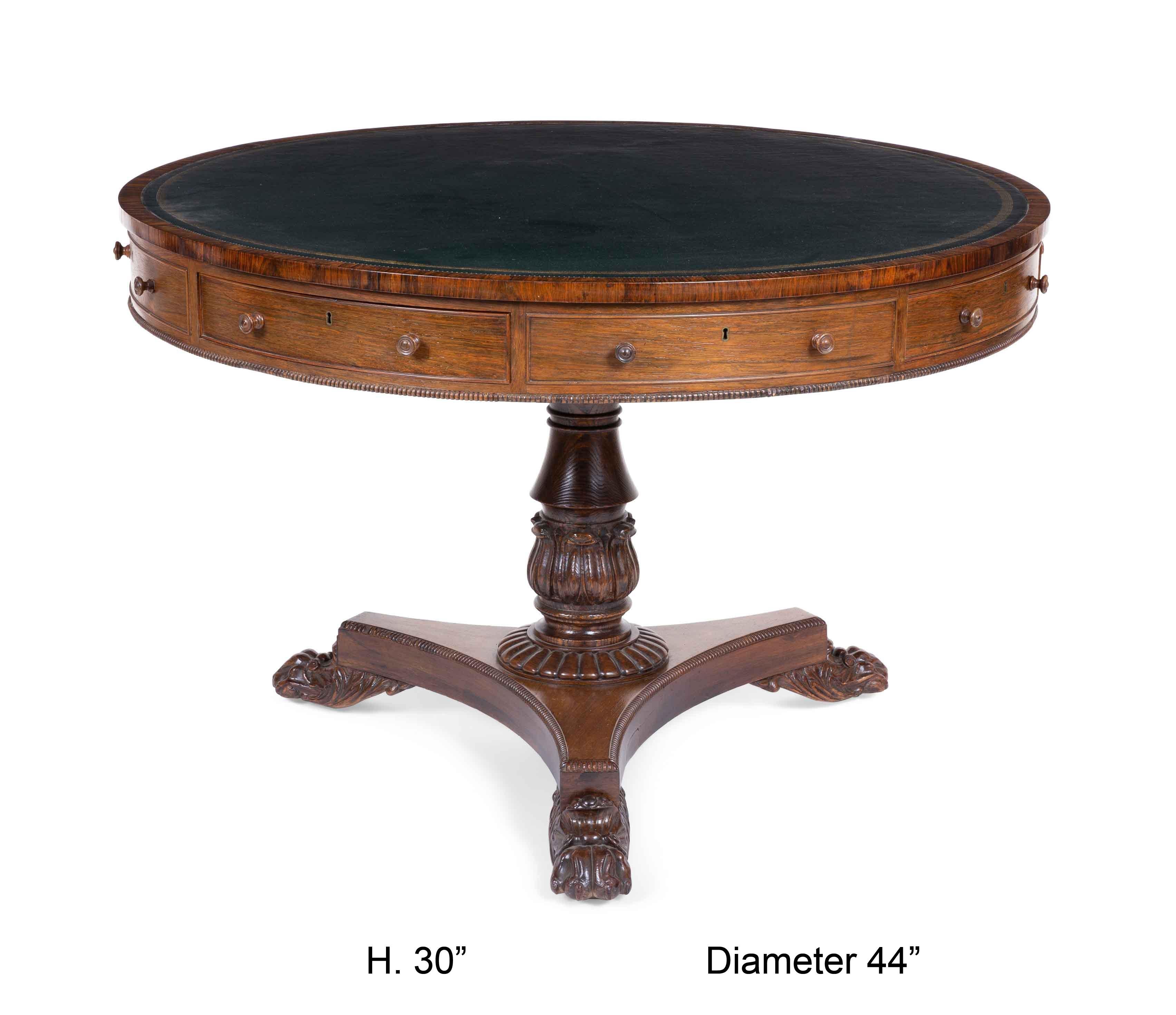 Beautiful early 19th century George IV walnut drum table
The circular top inset with a tooled leather writing panel, the frieze fitted with four real and four faux drawers. Resting on three finely carved lion feet.
 