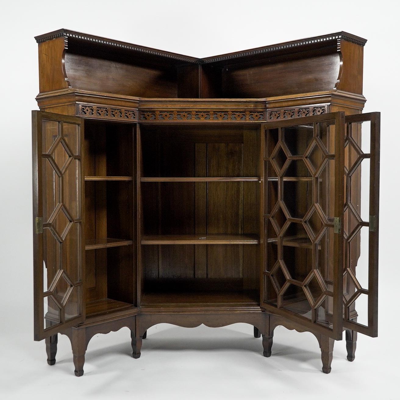 George Jack for Morris and Co. Stamped Morris and Co. 449 Oxford Street. Two matching Aesthetic Movement Walnut glazed corner cabinets, each with an open display area to the top and dentil molded decoration with blind fretwork floral decoration