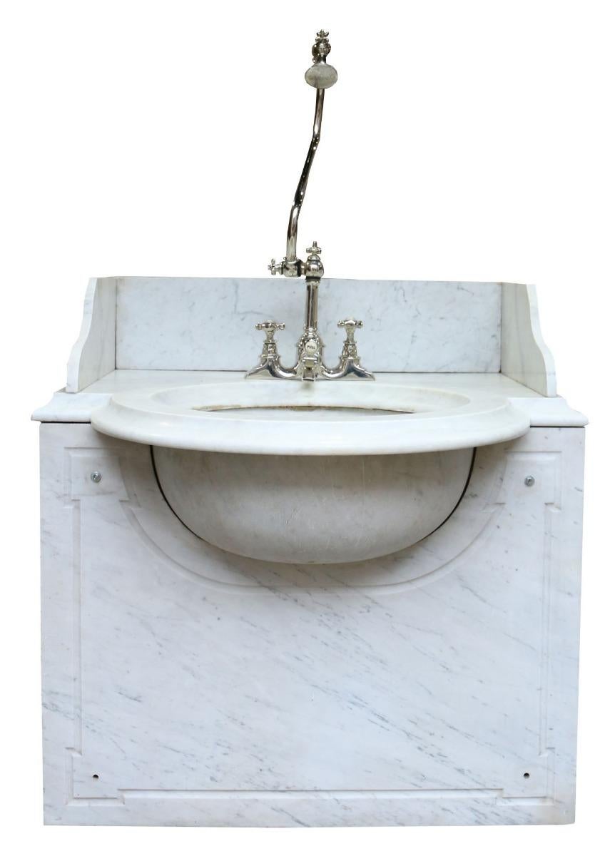 This impressive basin / sink and stand is made from white and grey Carrara marble, the tap is nickel plated. The under-mount bowl is made from a single piece of Carrara marble.

The taps have been reconditioned, including Nickel plating, and are