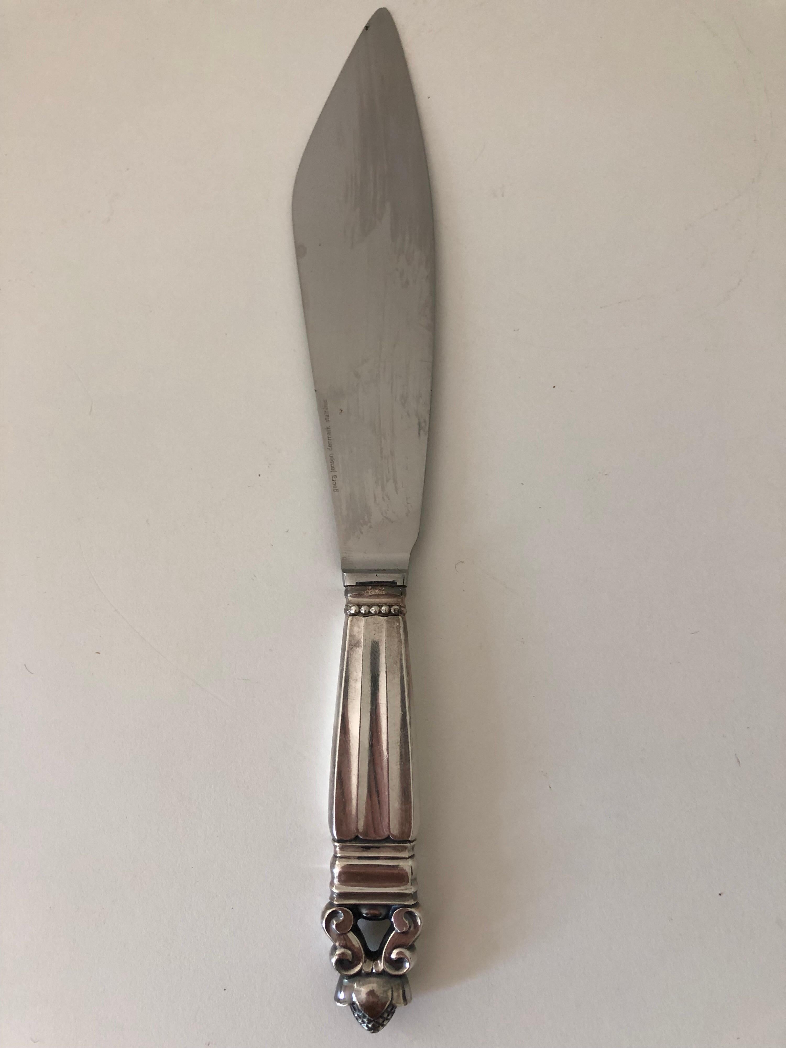 A vintage George Jensen acorn pattern cake knife. Sterling handle with stainless steel blade.
