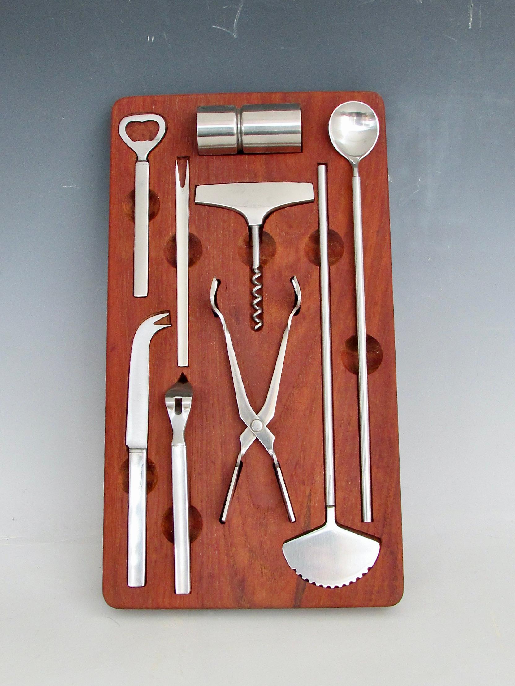 Height of elegance in cocktail bar ware cocktail preparation . Complete set of Magnus Stephensen for George Jensen  stainless steel bar accessories . To include pickle/olive fork . ice tongs , ice chipper , bottle opener , early style can opener,