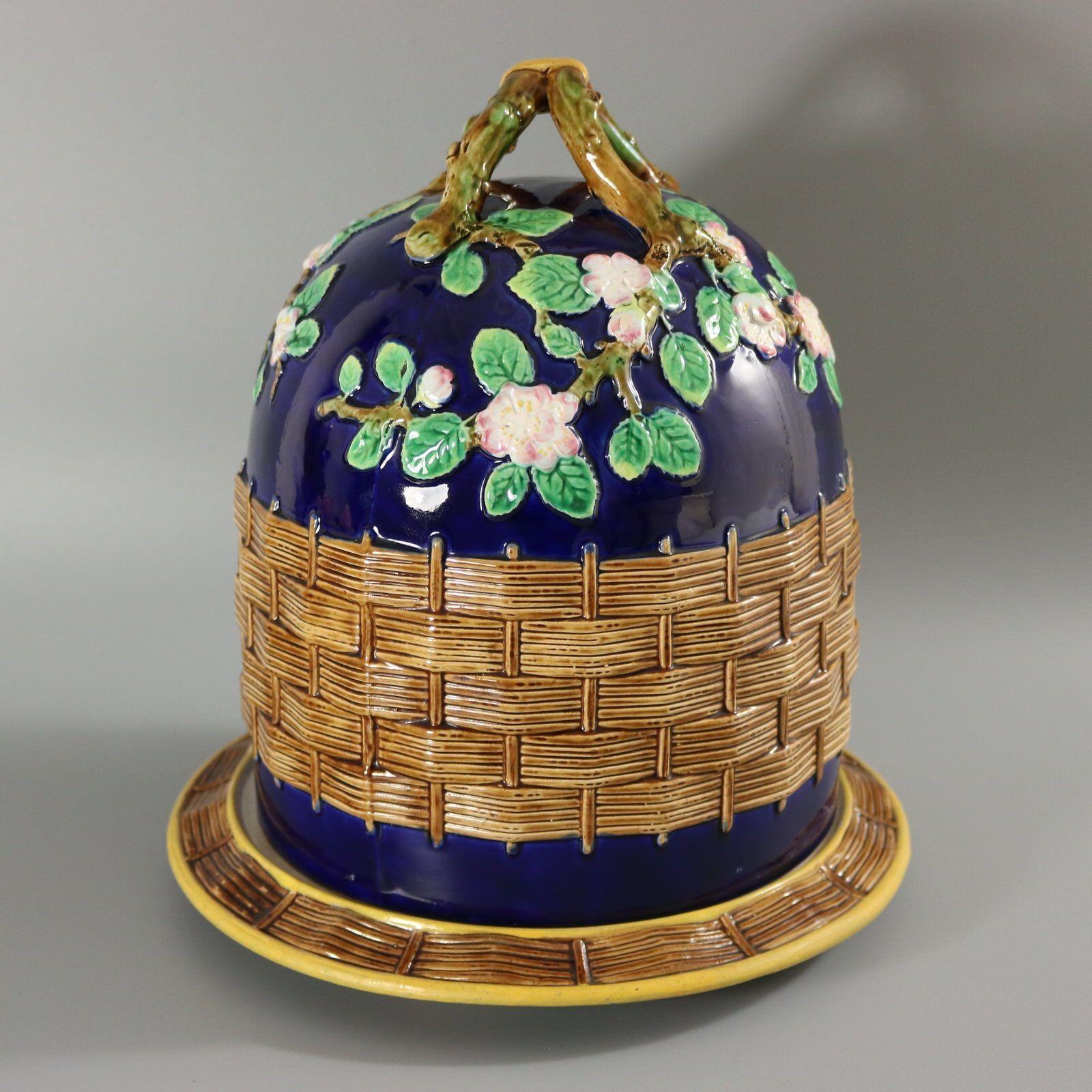 George Jones Majolica cheese keep which features a branch handle with apple blossoms. Basketweave to the sides. Cobalt blue ground version. Colouration: cobalt blue, brown, green, are predominant. The piece bears maker's marks for the George Jones