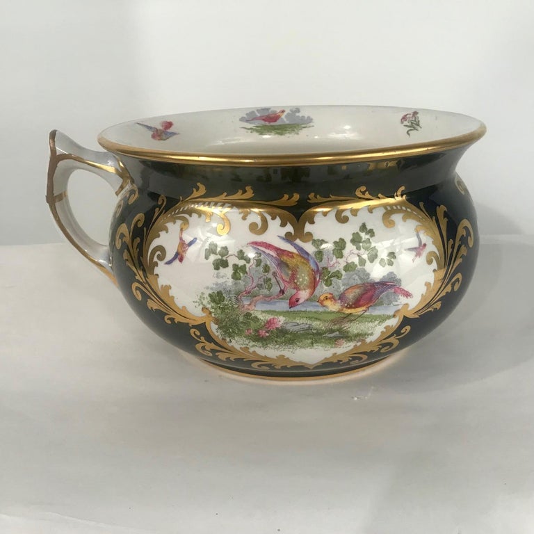This is really well-made. It is of typical form, compressed spherical, and with everted rim. It is painted in two large vignettes with exotic birds in a flowering landscape, and with other smaller reserves, even inside the rim. It is carefully and