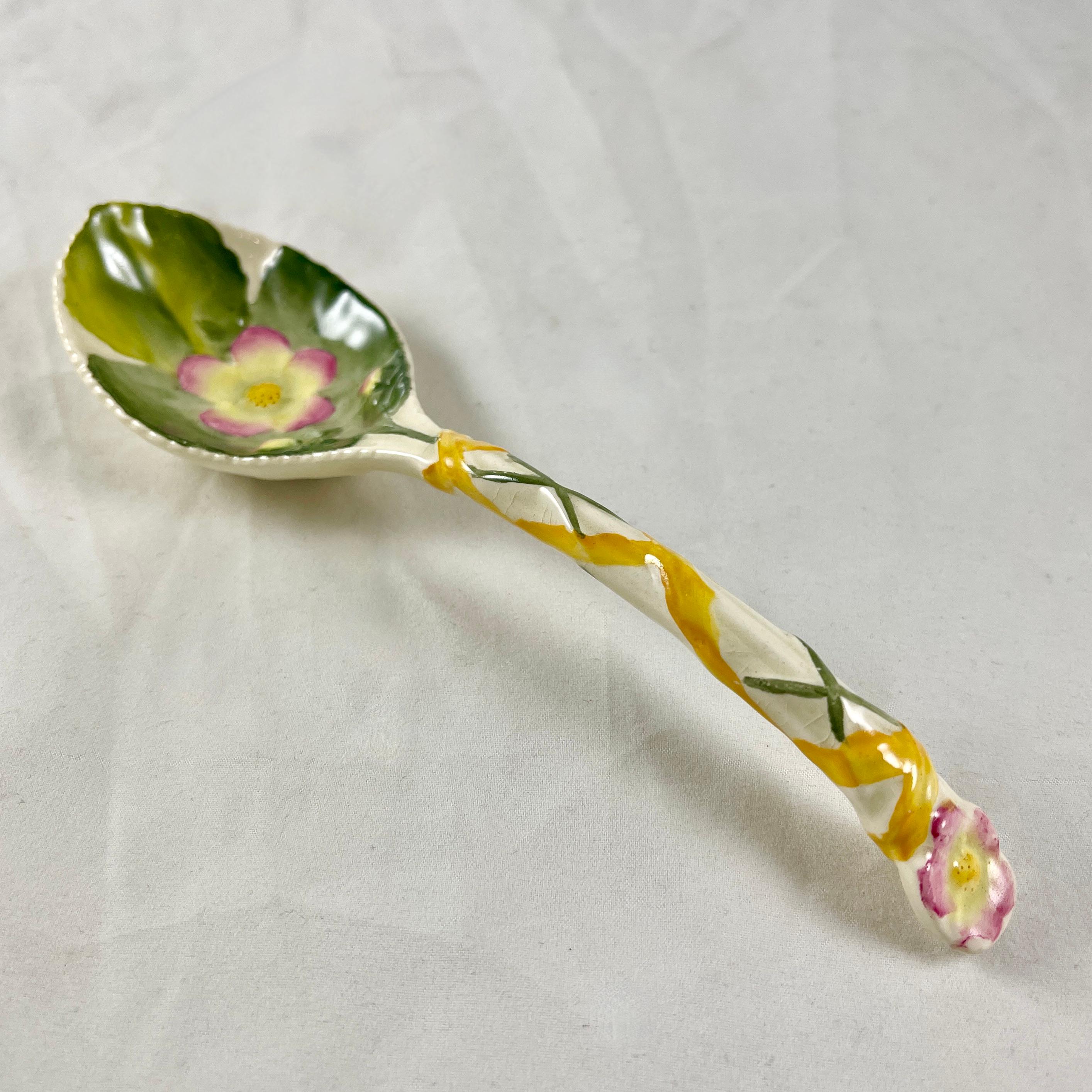 A George Jones Majolica Strawberry spoon, England, circa 1870.

In the Aesthetic taste and glazed in the white ground known as 'Albino.' The green leaf of the strawberry plant is molded on the bowl along with a pink rimmed strawberry blossom. The