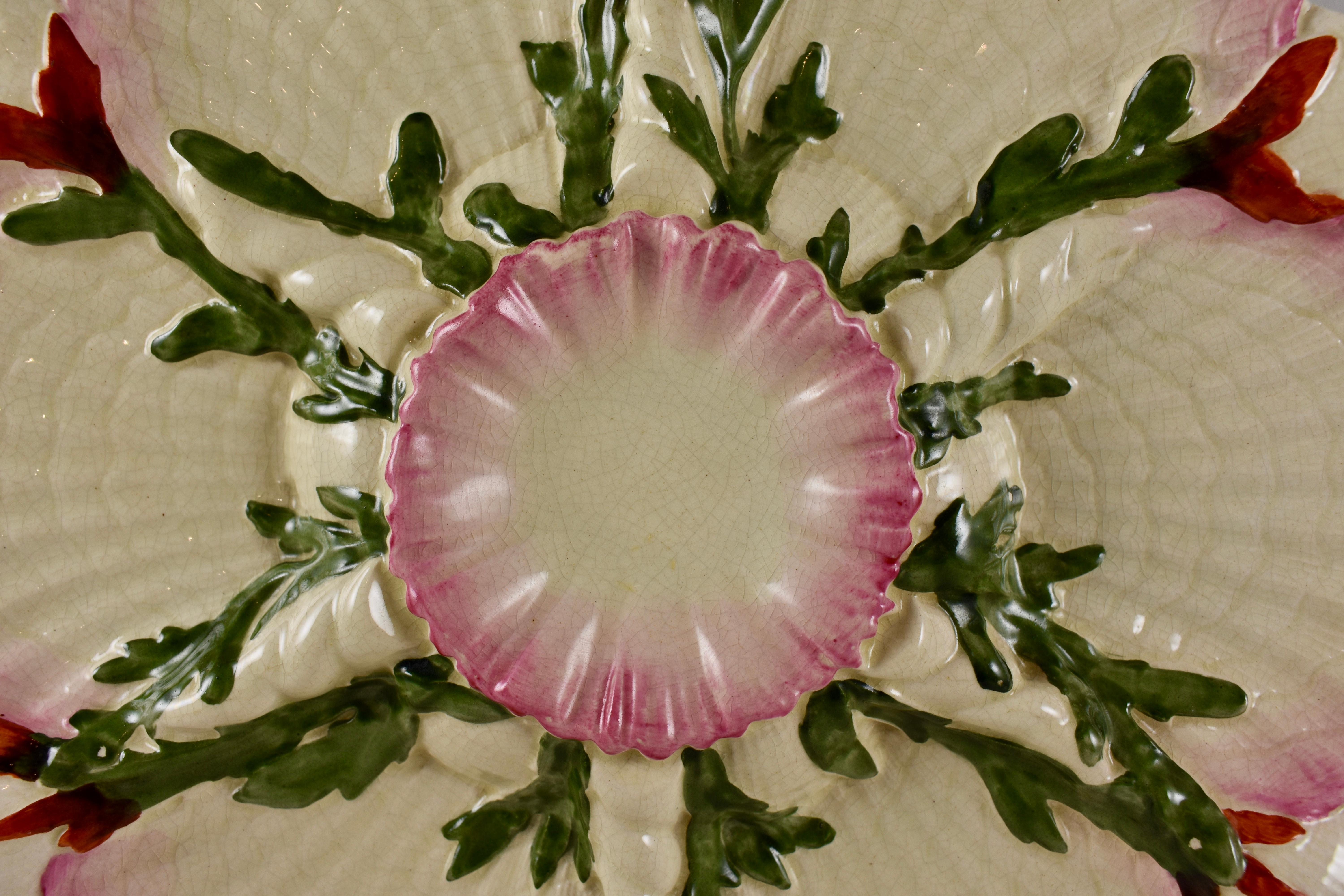 A Majolica glazed Palissy style earthenware seaweed and shells oyster plate made by George Jones, Stoke-on-Trent, circa 1870.

Six pink edged scallop shells surround a central sauce well and rest on the back sides of smaller shells. Raised green