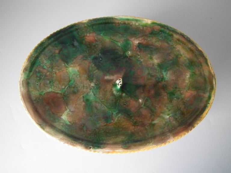 George Jones Majolica game pie dish which features a fox and hunting paraphernalia. Turquoise ground version. Coloration: Turquoise, green, brown, are predominant. Bears a pattern number, '2262'.