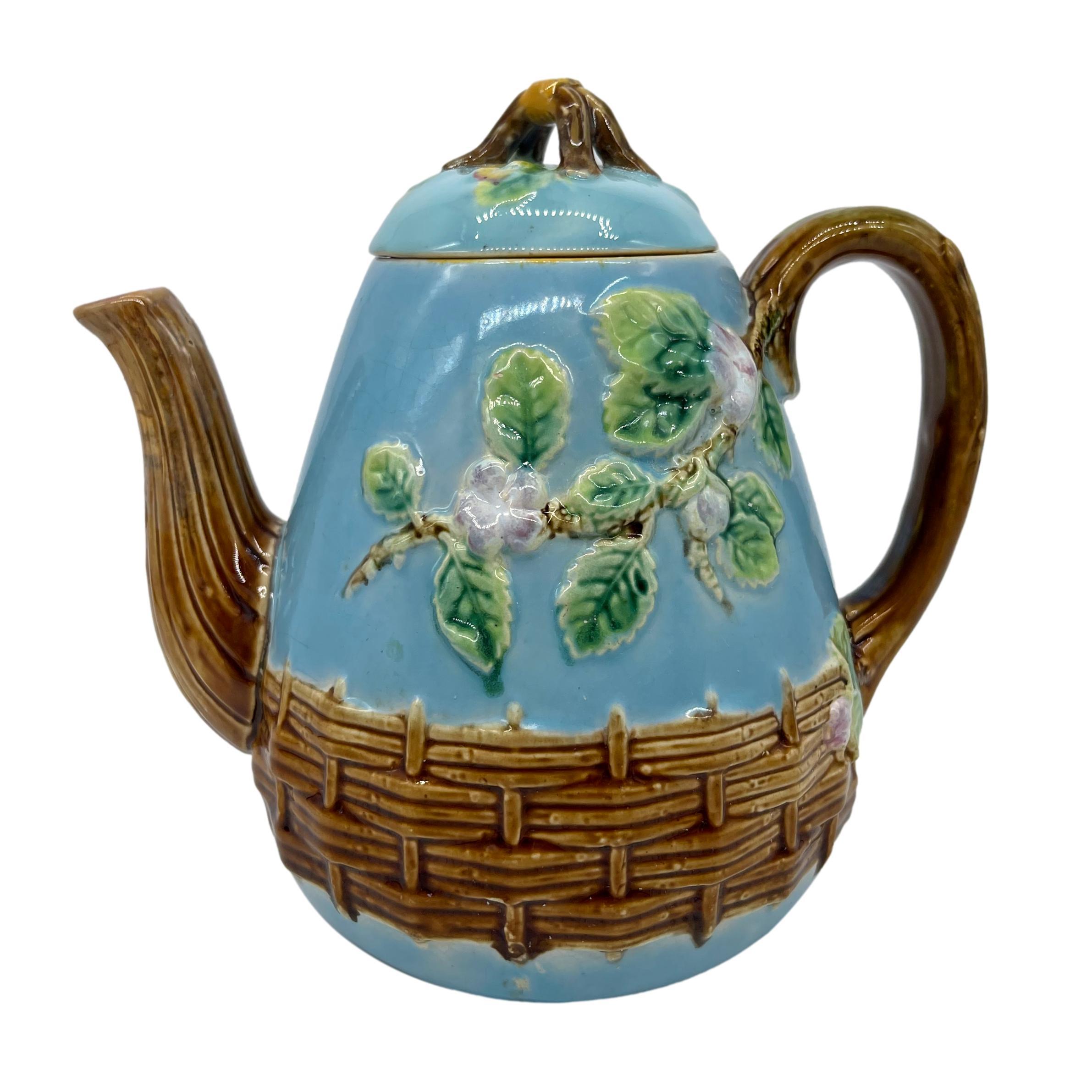 George Jones Majolica 'Apple Blossom' Teapot, the pear-shaped teapot and lid molded with blooming apple tree limbs, with a mossy branch handle and spout, with basketweave banding, the cover surmounted by yellow-banded twigs forming the knop, the