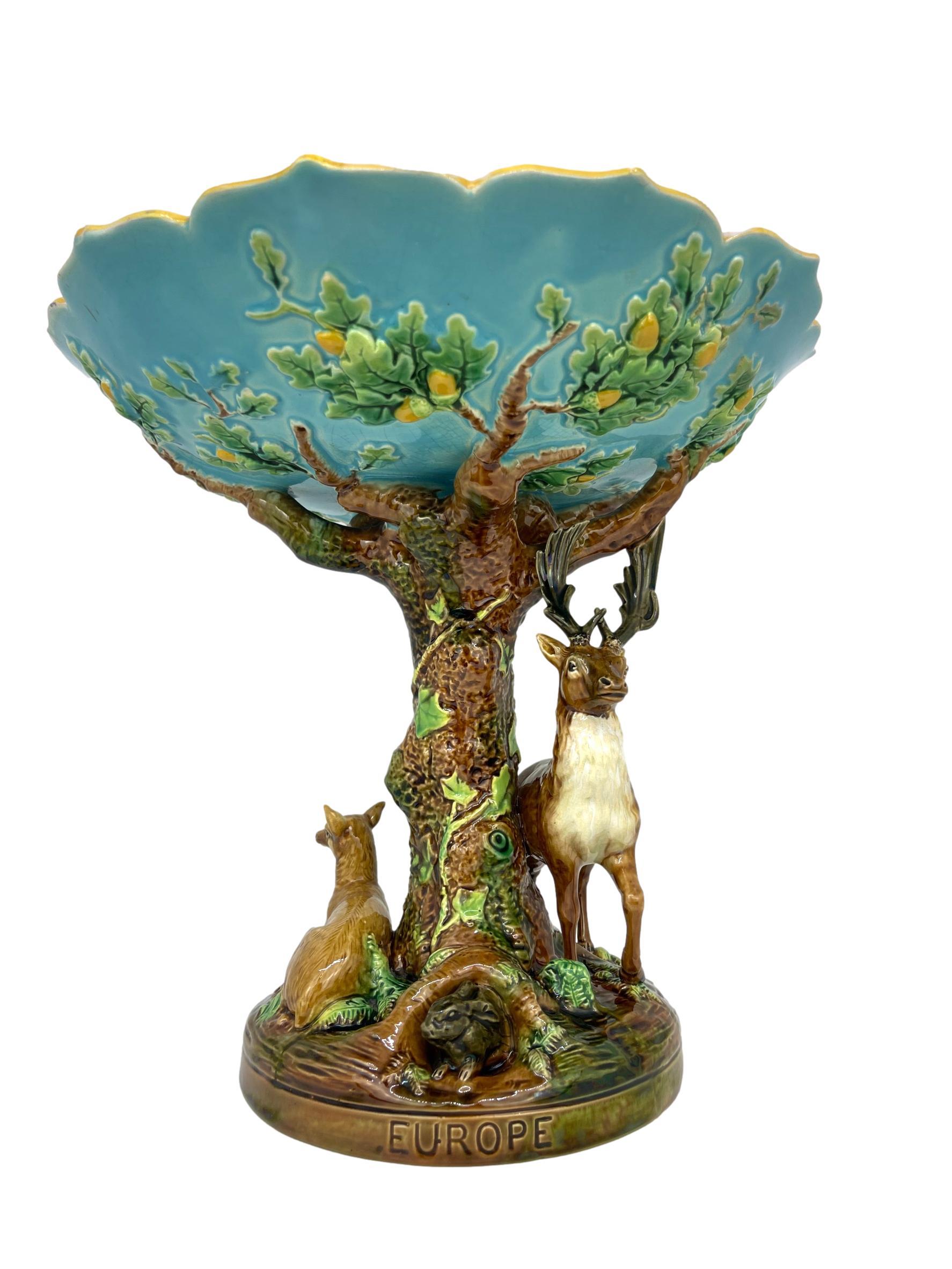 George Jones Majolica 'EUROPE' centerpiece, English, 1872 
The shaped bowl supported by an oak tree, with a standing stag, reclining doe, and a rabbit, the bottom band impressed, 'EUROPE,' the reverse with British Registry lozenge for 23 December