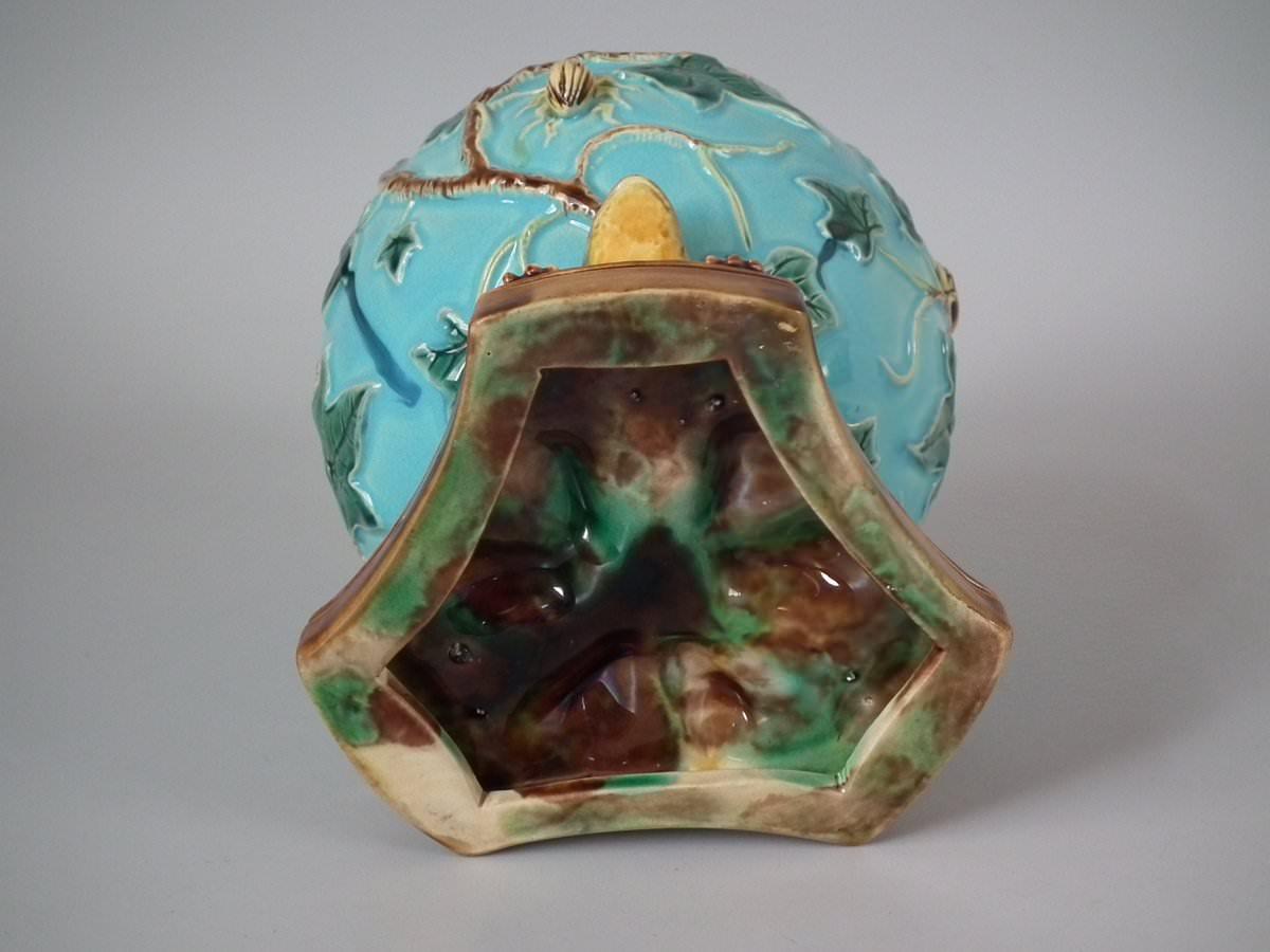 George Jones Majolica vase which features three frogs supporting a vase covered with ivy and insects. Turquoise ground version. Colouration: turquoise, green, brown, are predominant.