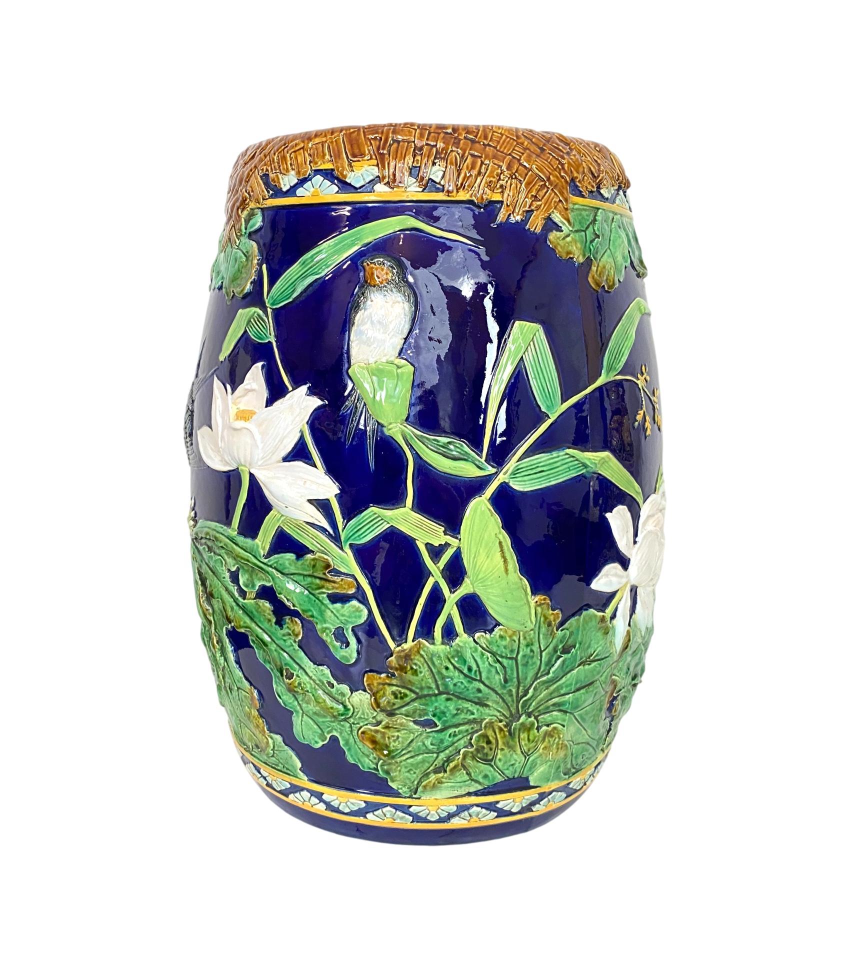 George Jones Majolica Garden seat, of drum-form, naturalistically modeled with Herons and Swallows in a pond setting with water lilies and pond grasses, with Japonisme elements, including a stylized turquoise and yellow glazed band to the top and