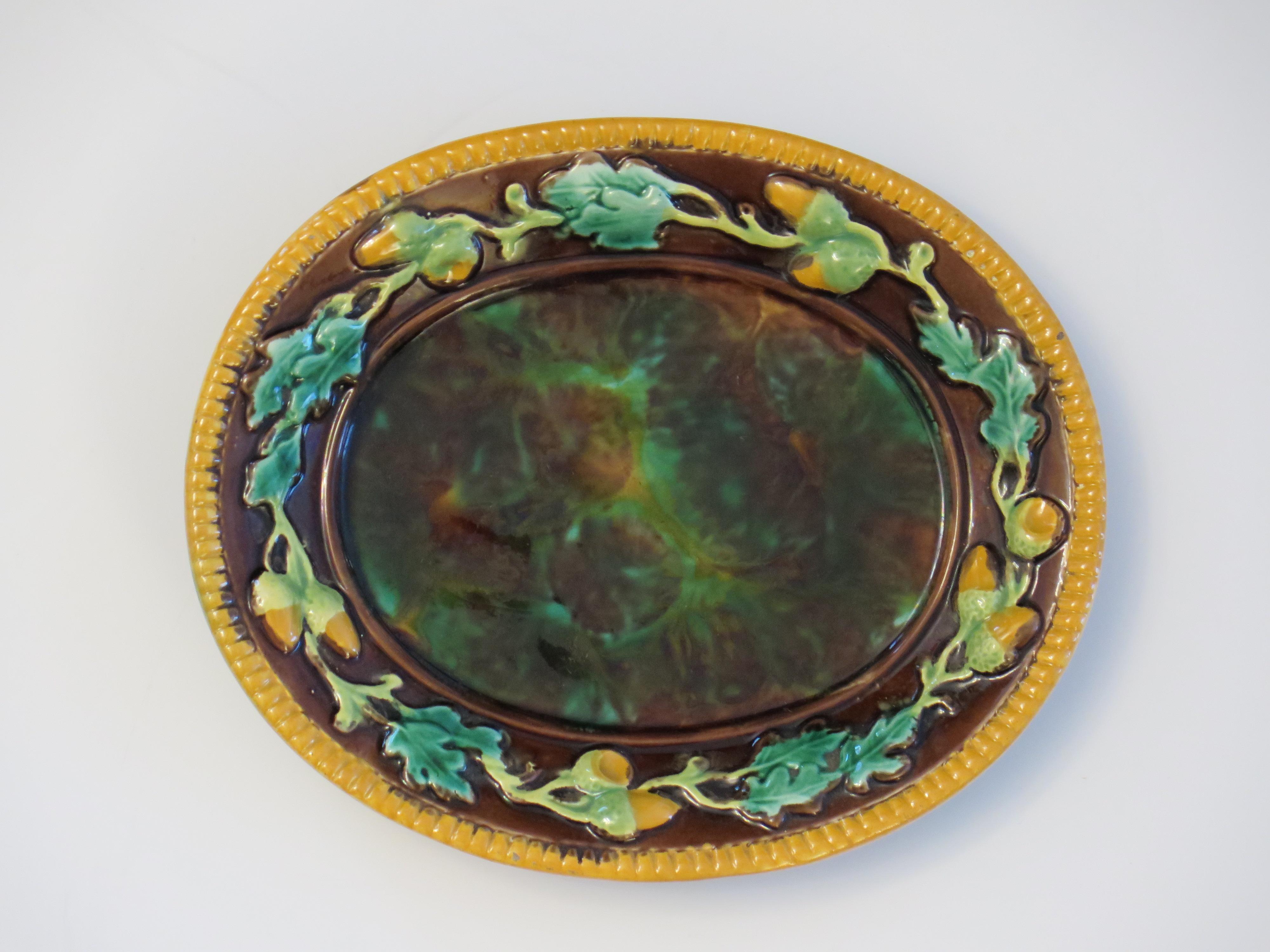 This is a 19th Century Majolica oval dish or small platter by George Jones, fully marked and dating to the Victorian English period 1861 to 1878.

This is a small oval majolica dish on a raised foot, by George Jones and is a very good example of its