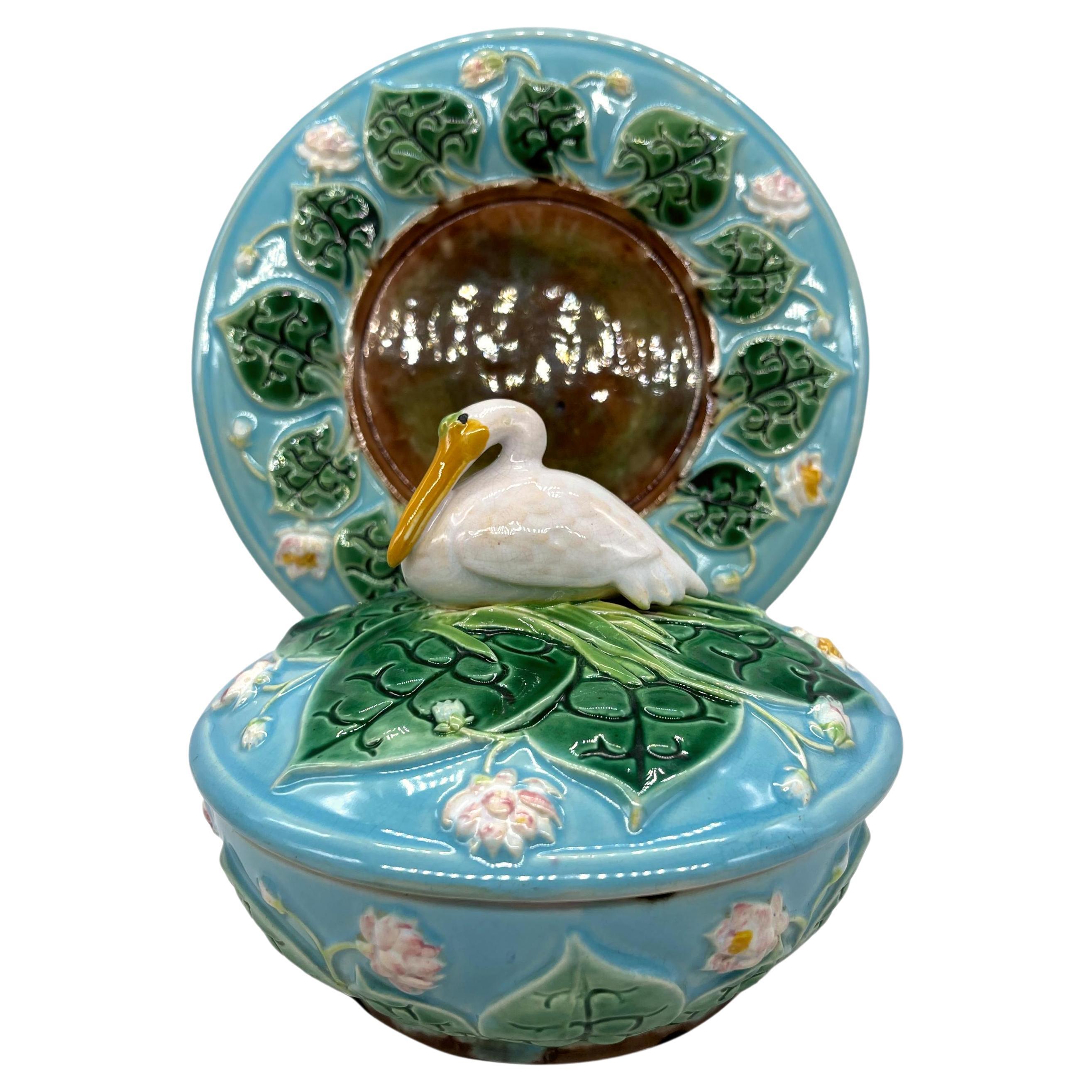 George Jones Majolica Pâté Server with Stand & Cover, English, Dated 1875.
The three pieces modleld as a turquoise glazed pond with relief-molded lily pads and flowering pond lilies, the server and cover interiors glazed in lilac, the stand with