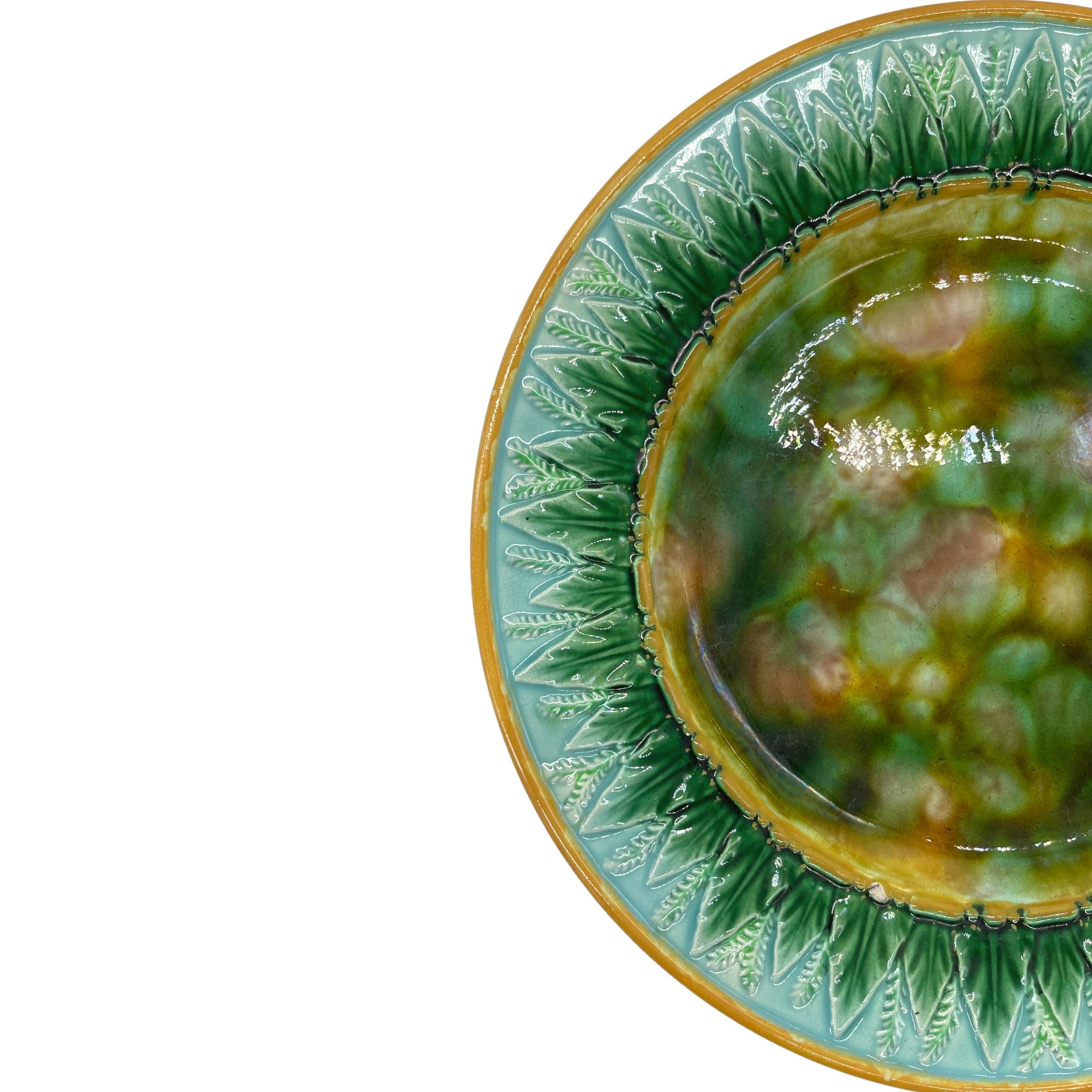 George Jones Majolica Plate, the Center with Tortoiseshell Mottling, the 9.25-in plate with Tortoiseshell Mottling to the center, bordered with green-glazed stylized stiff wheat leaves and wheat stalks on a turquoise-glazed ground, the inner and