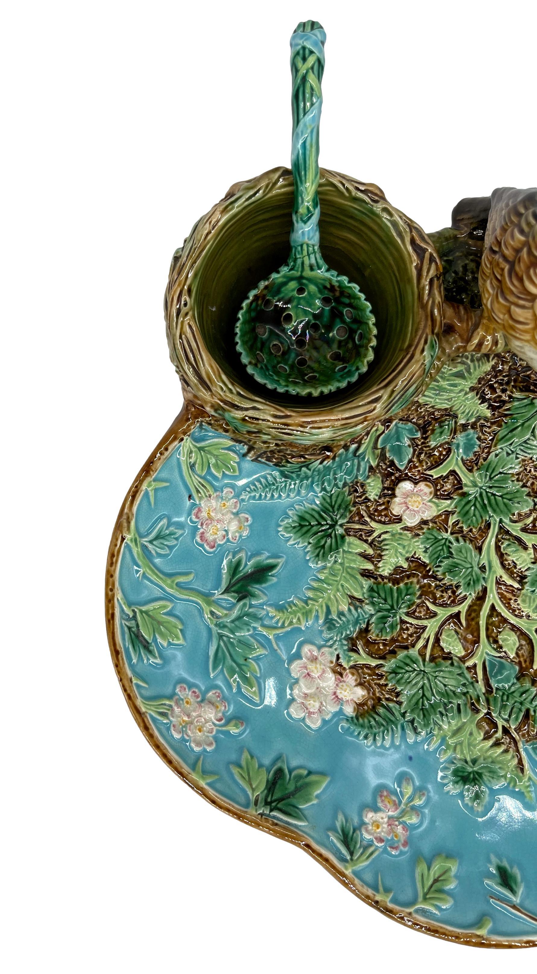 George Jones Majolica Strawberry Server, ca. 1870, Design Number 2559, the trefoil dish naturalistically modelled with blossoming strawberry plants and ferns on a turquoise and rustic ground, surmounted with a life-size thrush perched on simulated