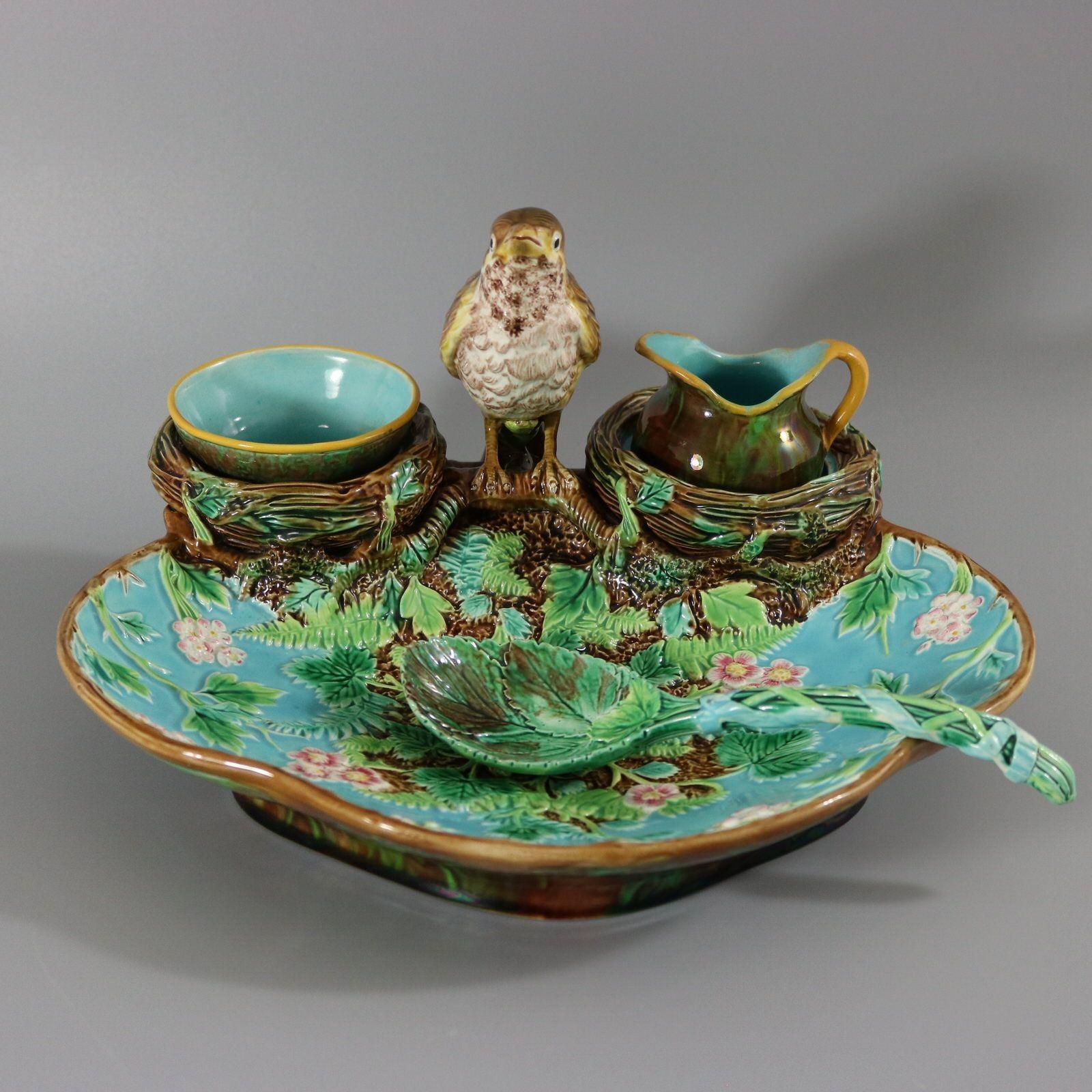 George Jones Majolica strawberry server, spoon, sugar pot and creamer which features a bird (Thrush) perched on the rim between two hollow nests which form wells for the removable creamer and sugar bowl. Strawberry flowers and leaves to the main