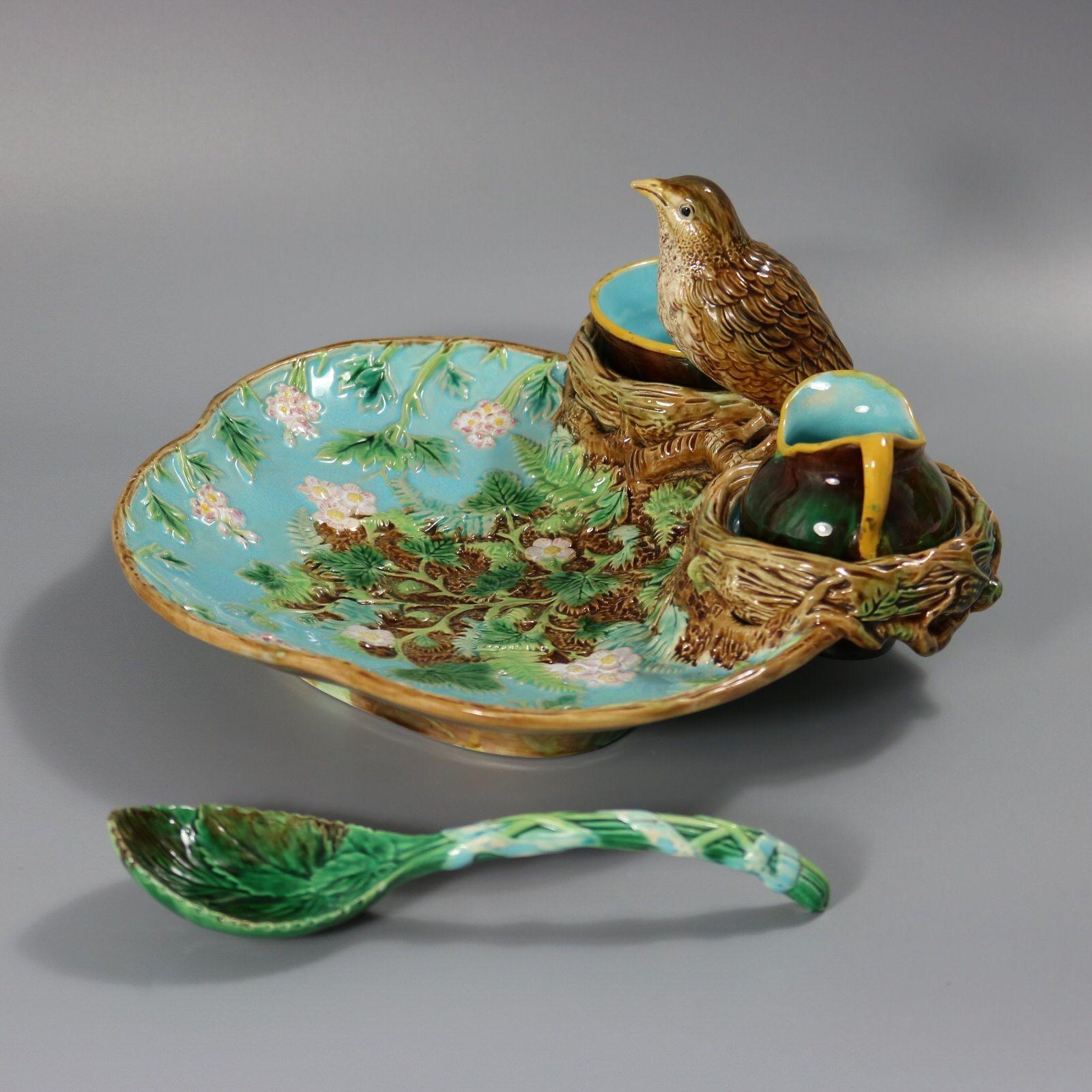 George Jones Majolica strawberry server, spoon, sugar pot and creamer which features a bird (song thrush) perched on the rim between two hollow nests which form wells for the removable creamer and sugar bowl. Strawberry flowers and leaves to the