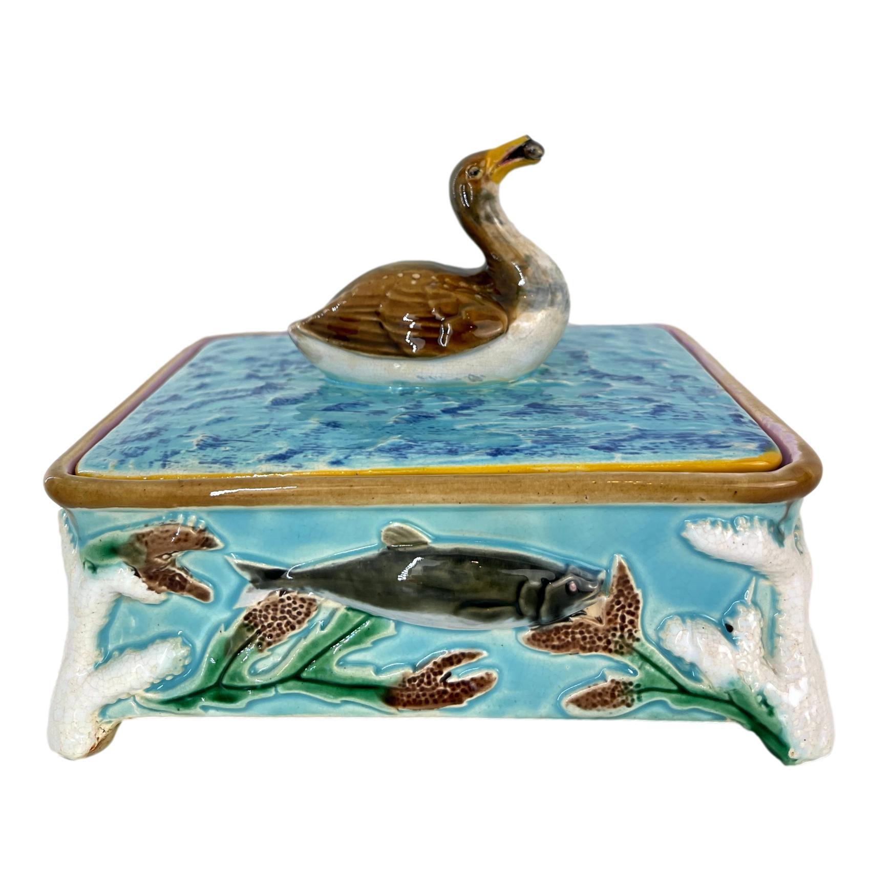 George Jones Majolica Turquoise Sardine Box, Duck (actually a Grebe) and Fish, English, ca. 1874, the box molded in high relief with a salmon on each of the four sides, each corner with molded coral forming the raised feet, the lid with simulated