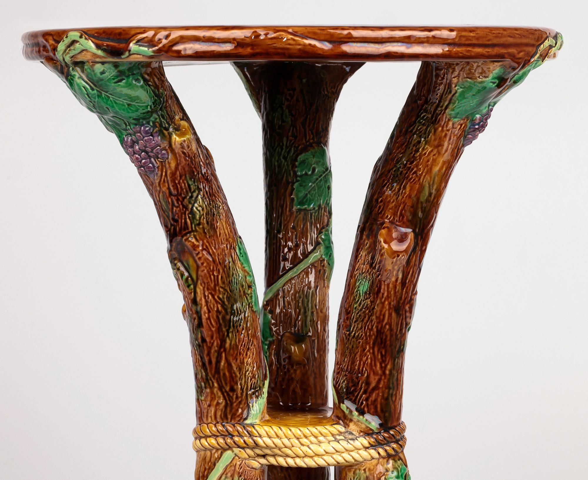 A rare and large antique majolica floor standing pedestal by renowned and sought after maker George Jones and dating from around 1865. The pedestal is formed as three curved branches tied and joined in the middle extending from a solid and flat