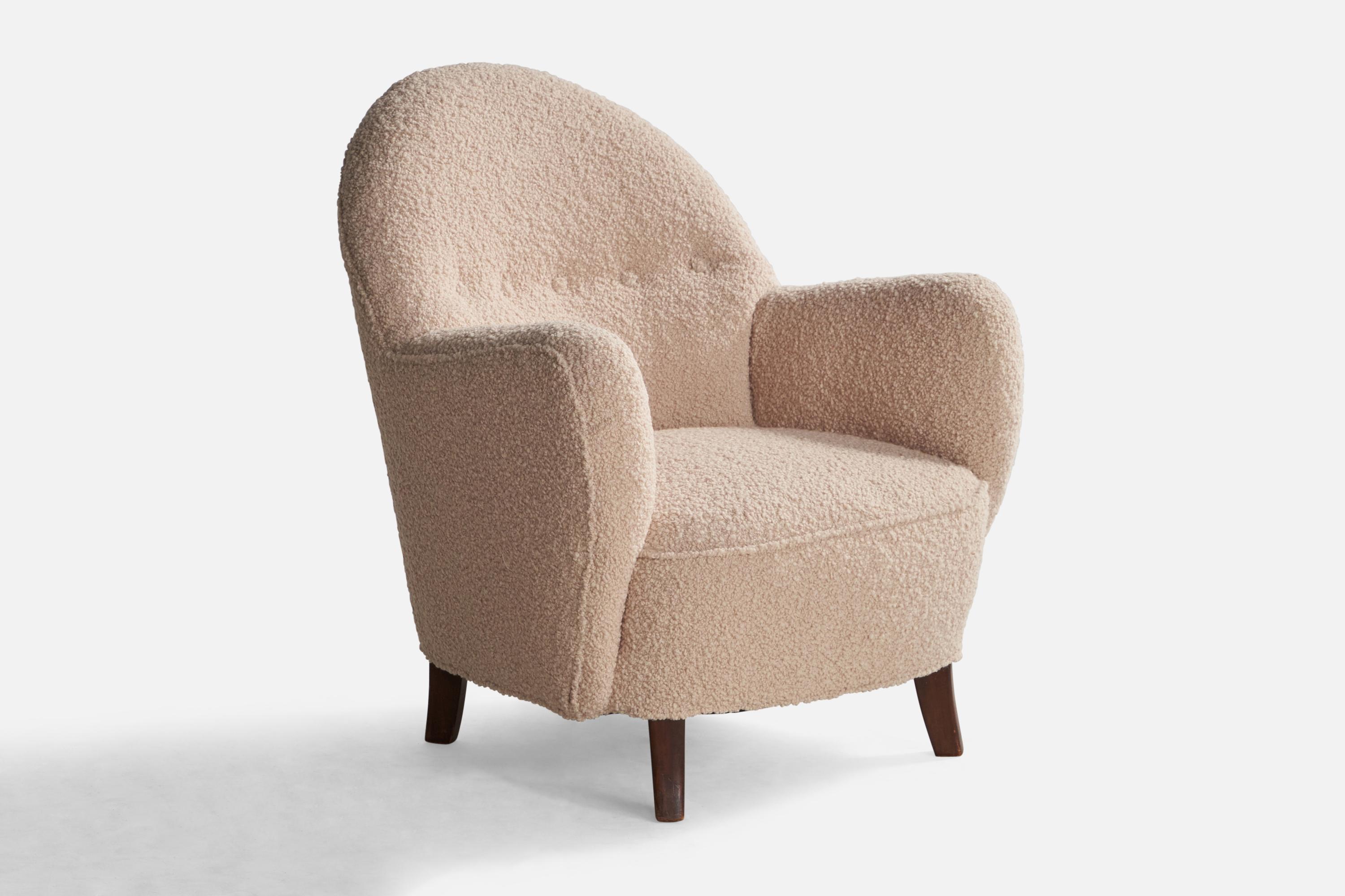 A dark-stained wood and light pink bouclé fabric lounge chair designed and produced by George Kofoed, Denmark, 1940s.

Seat height: 14.5”