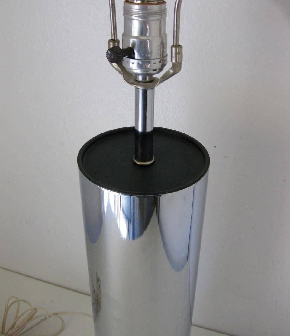 Mid-Century Modern chrome finished cylinder table lamp designed by Robert Sonneman for George Kovacs. Measures 16” tall to top of chrome cylinder, and 29.25” tall to top of harp.